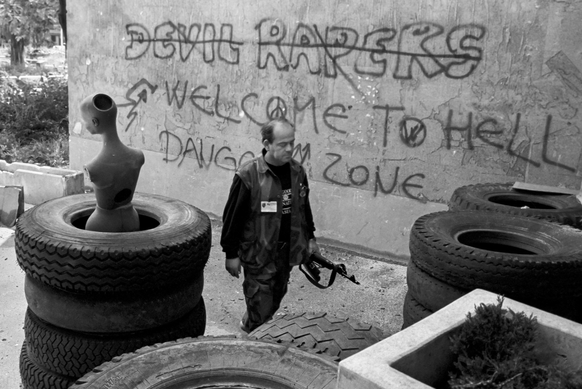 A Bosnian Army soldier walks past a mannequin used to try and draw fire from Bosnian Serb Army positions in Sarajevo on June 10, 1992.