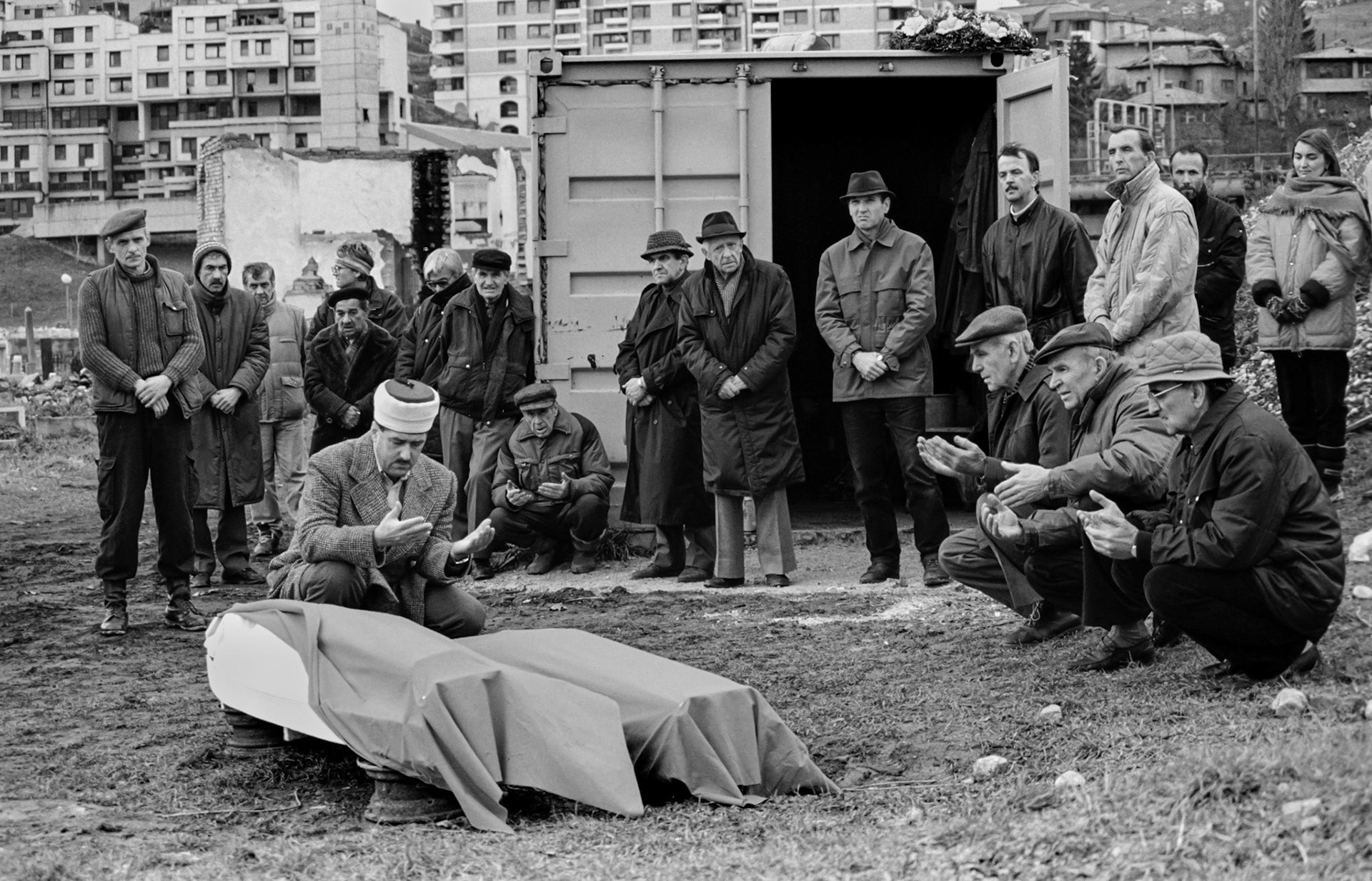 Mourners of several religions at the improvised funeral of two Muslims in the besieged Bosnian capital Sarajevo on December 9, 1993. Funerals can often not take place in the regular cemeteries due to incoming sniper and artillery fire.