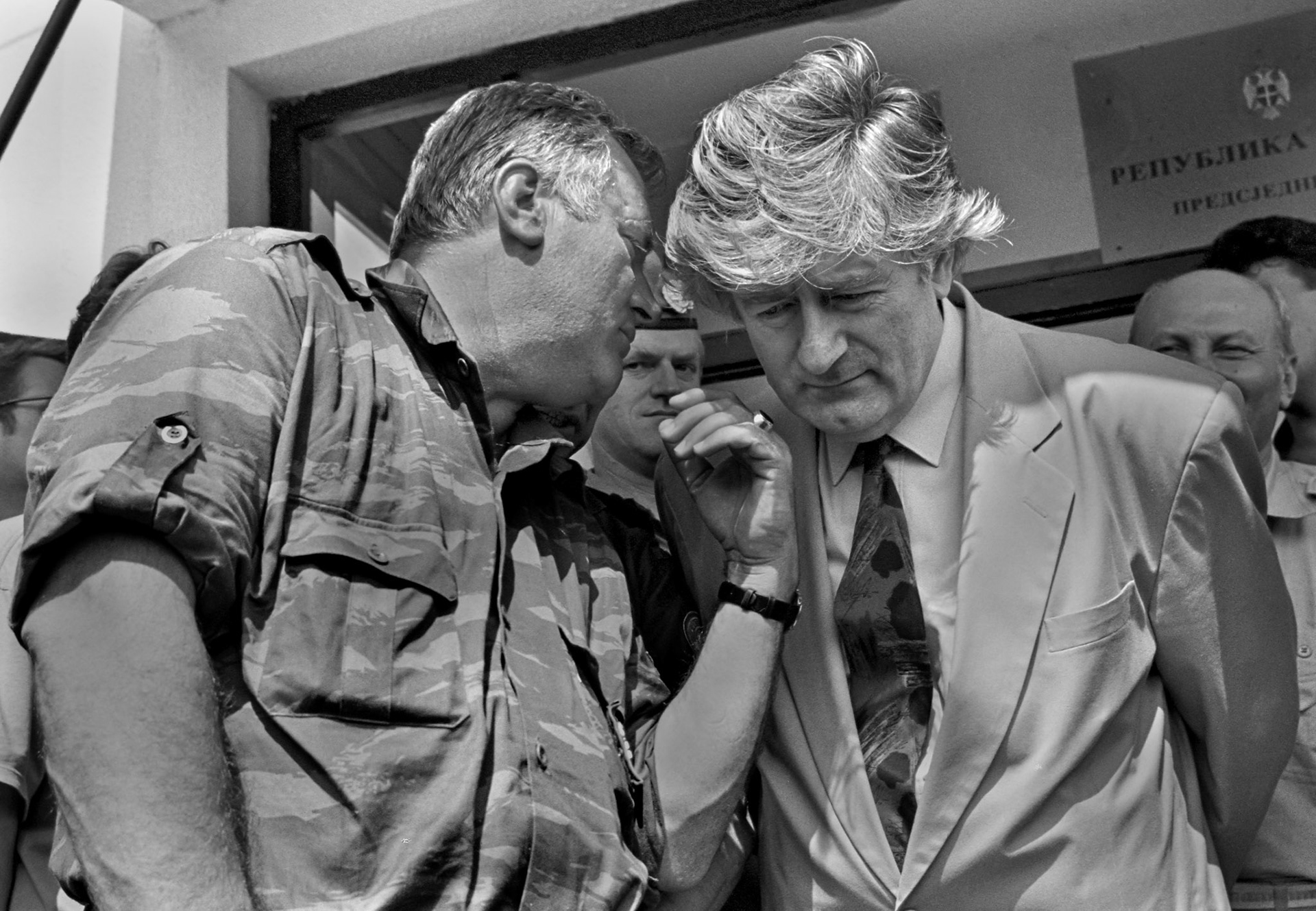 Bosnian Serb leader Radovan Karadzic (right) listens to his top commander, general Ratko Mladic outside their Pale headquarters on Thursday, August 5, 1993.