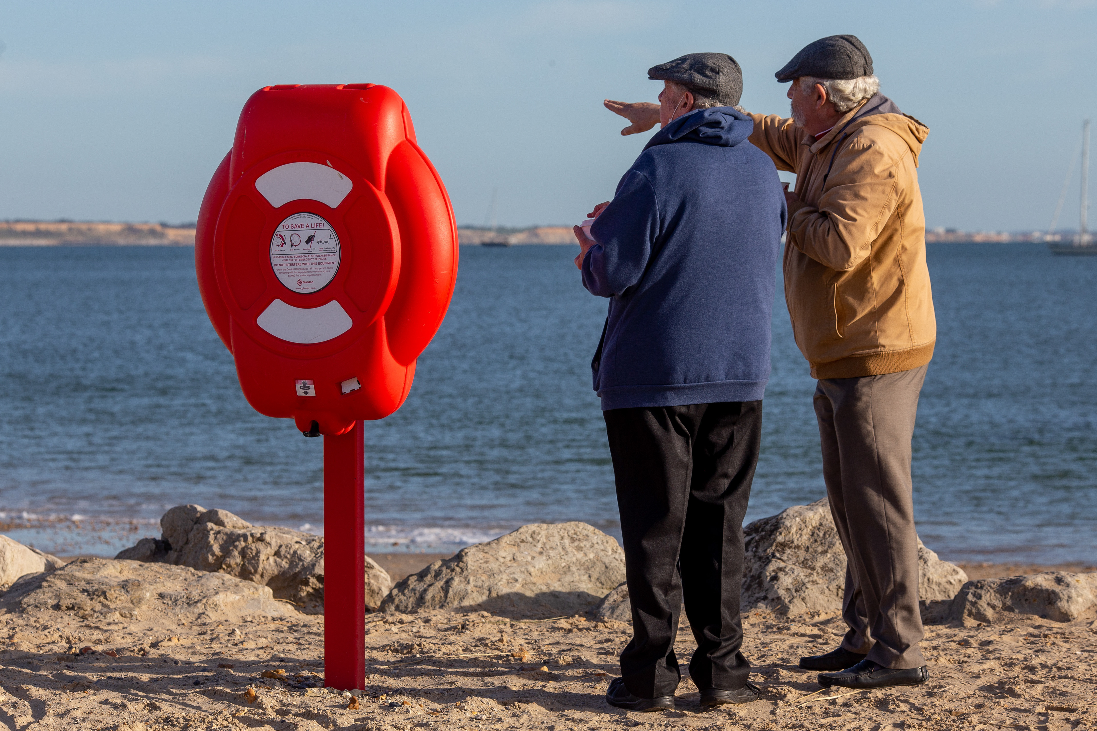 Pensioners discussing the view at Hengistbury Head in Dorset