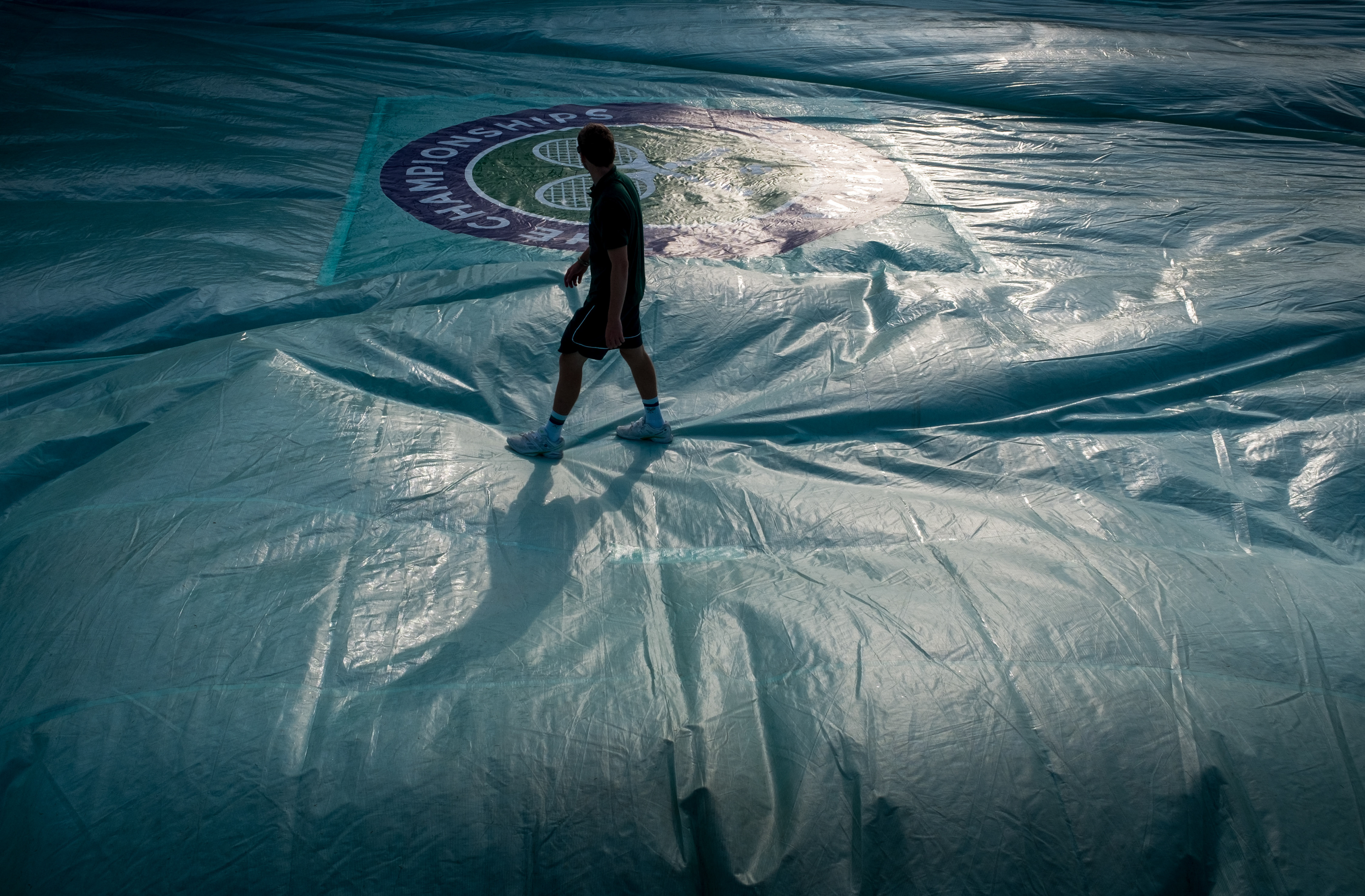 Ground Staff prepare the courts early in the morning at The All England Lawn Tennis Club