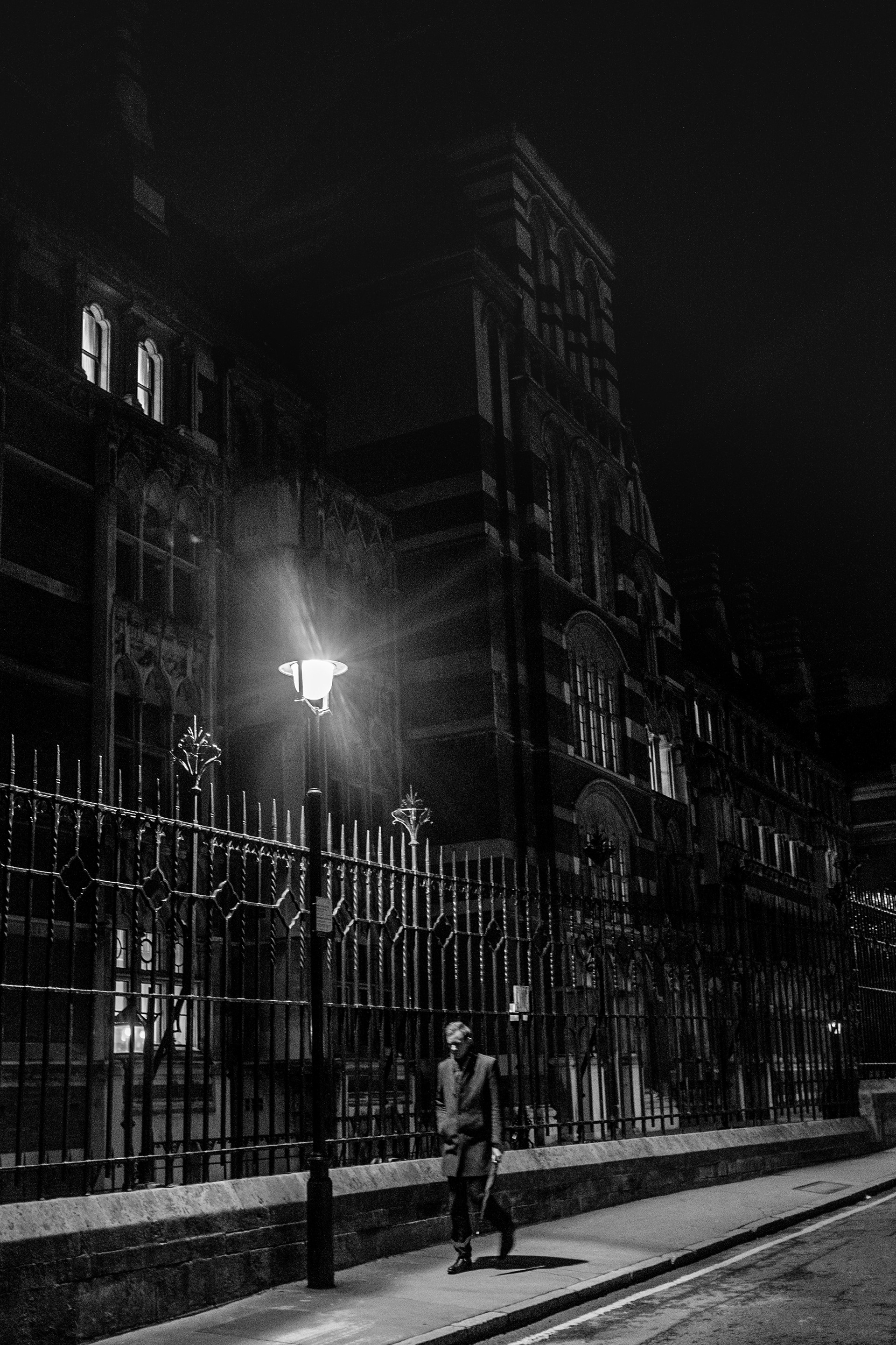 Pedestrian walks past the side of the Royal Courts of Justice ion London