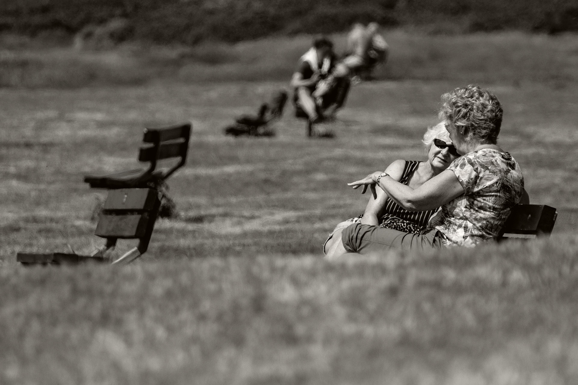 Ladies sit and chat on the cliff tops at Fisherman's Walk in Bournemouth