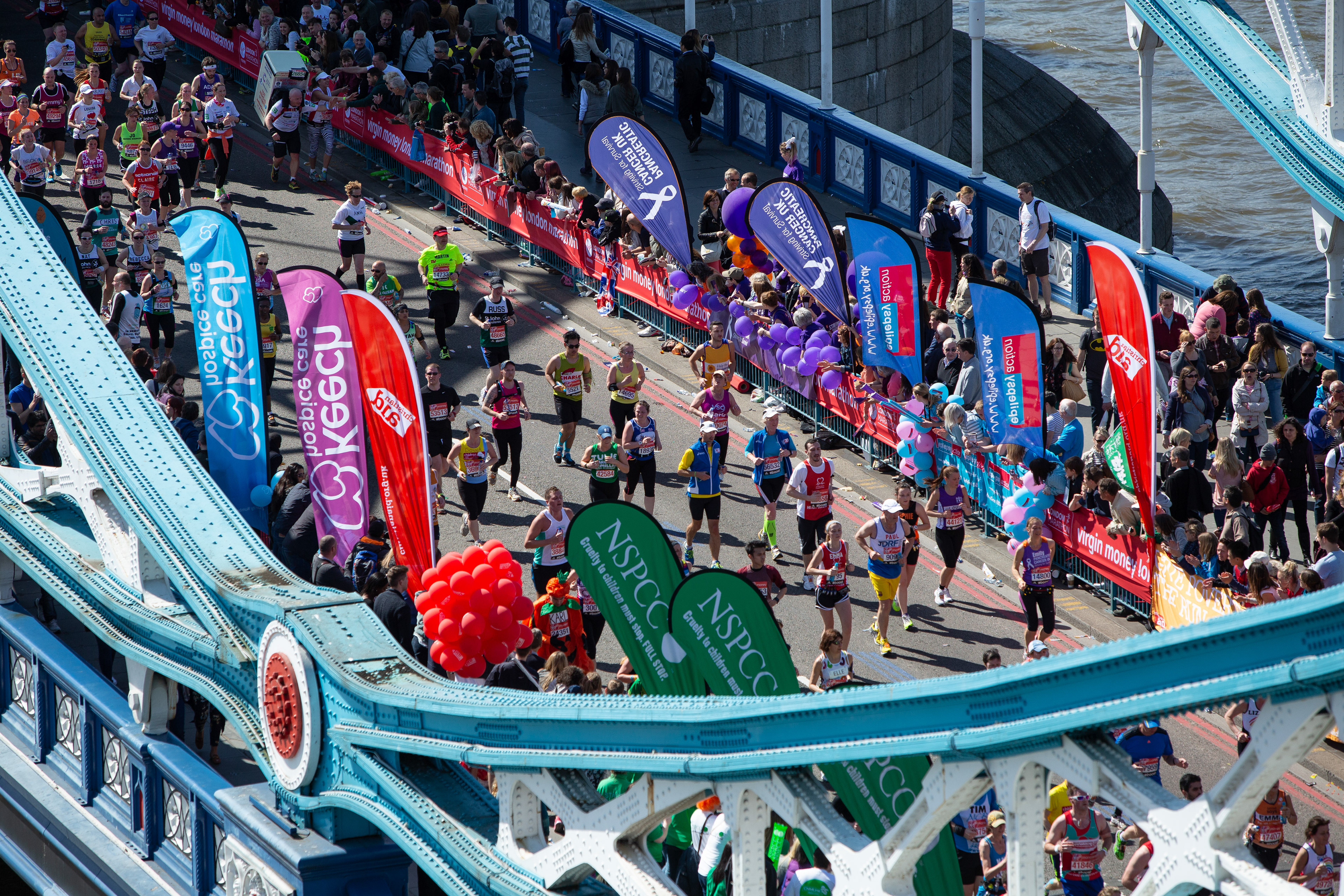 Runners cross Tower Bridge during the London Marathon
