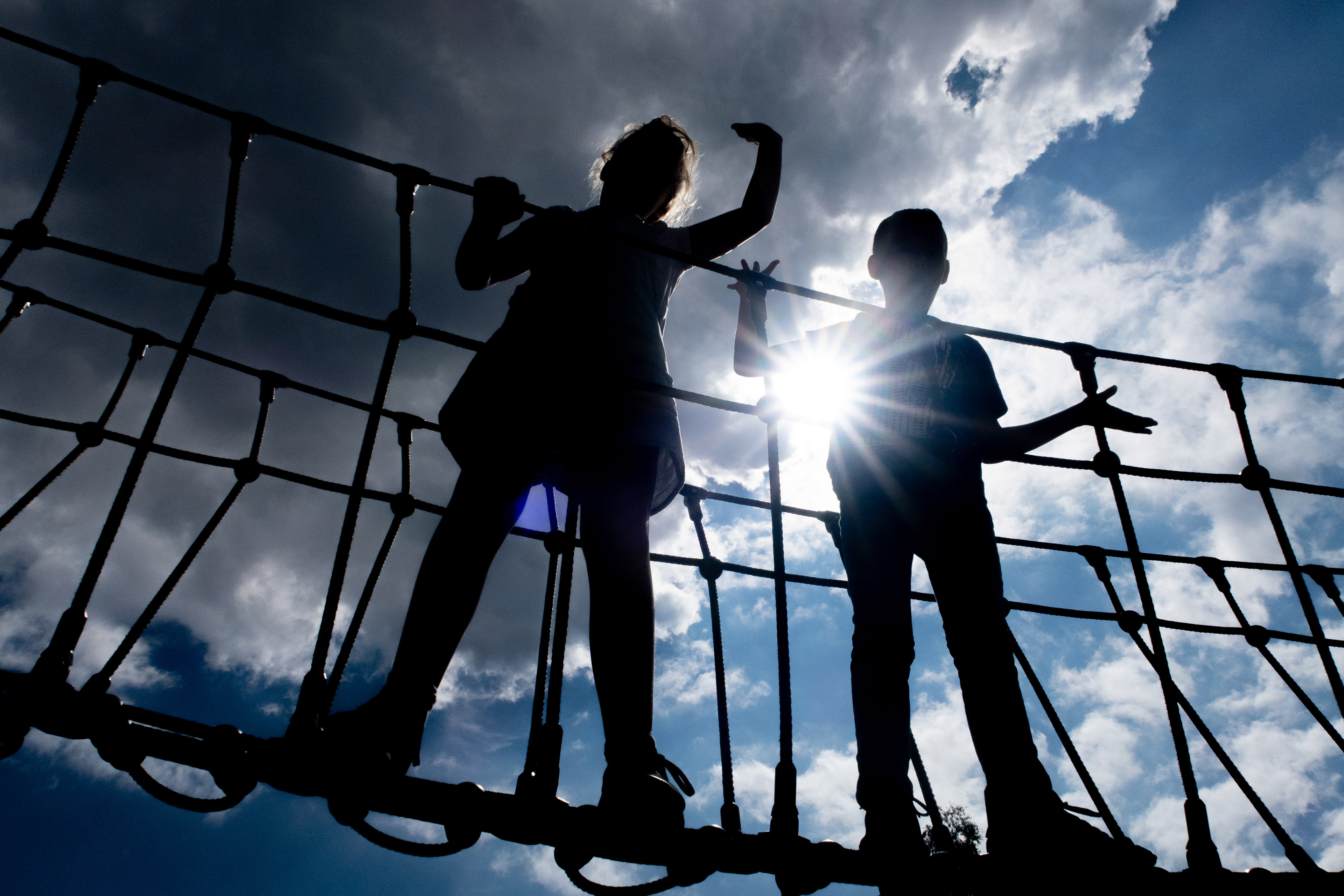 Children play on a rope walkway at a leisure park in Devon