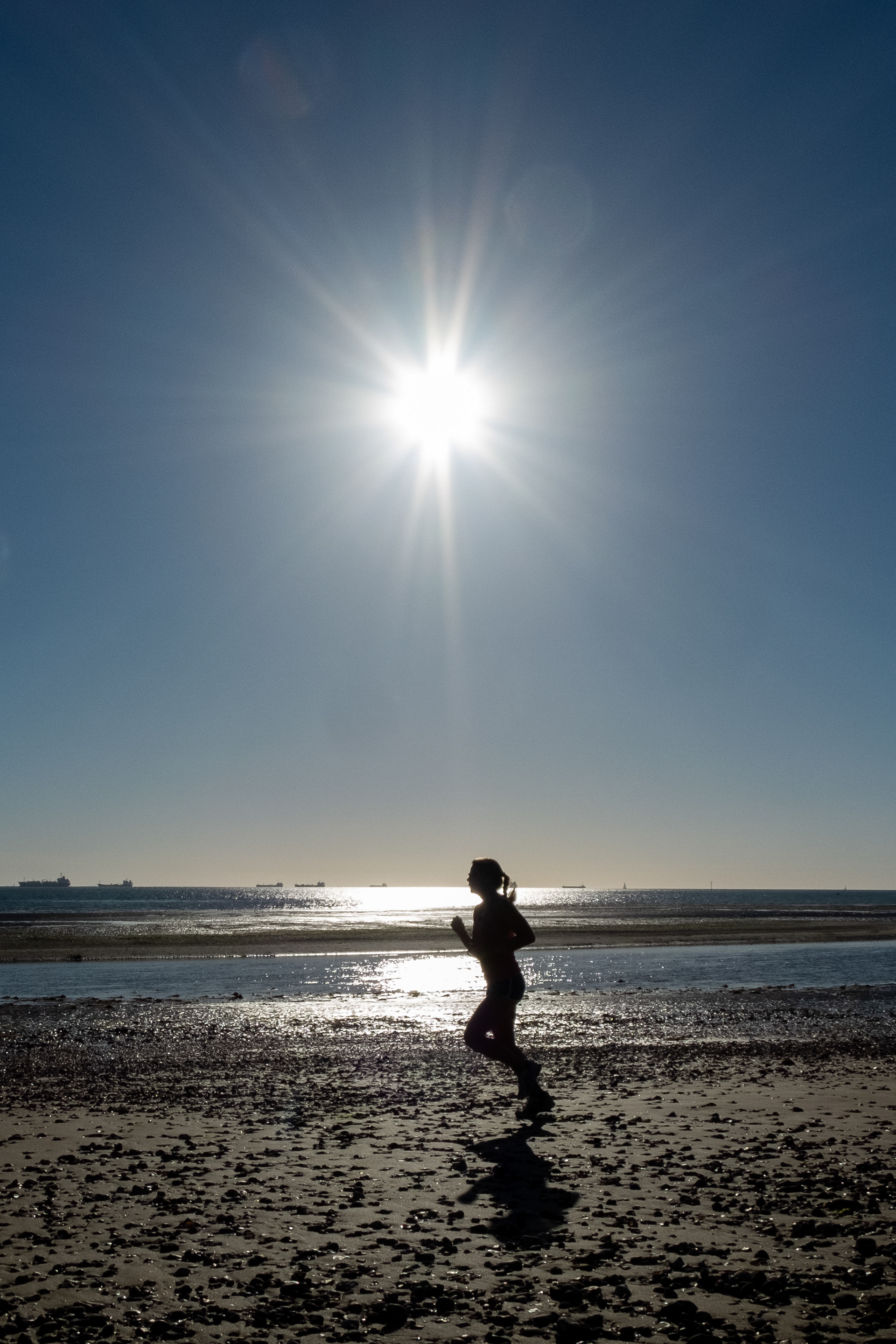 Jogger on the beach at Priory Bay on the Isle of Wight