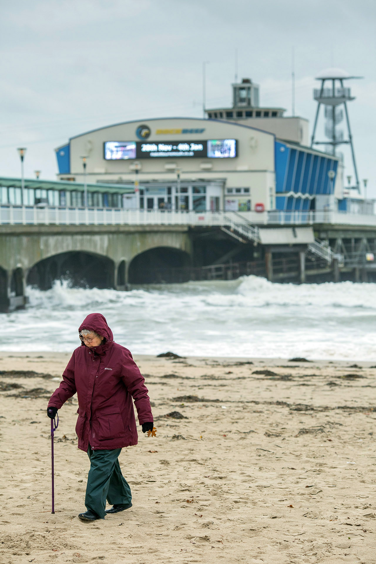 Elderly visitor to Bournemouth beach after a storm
