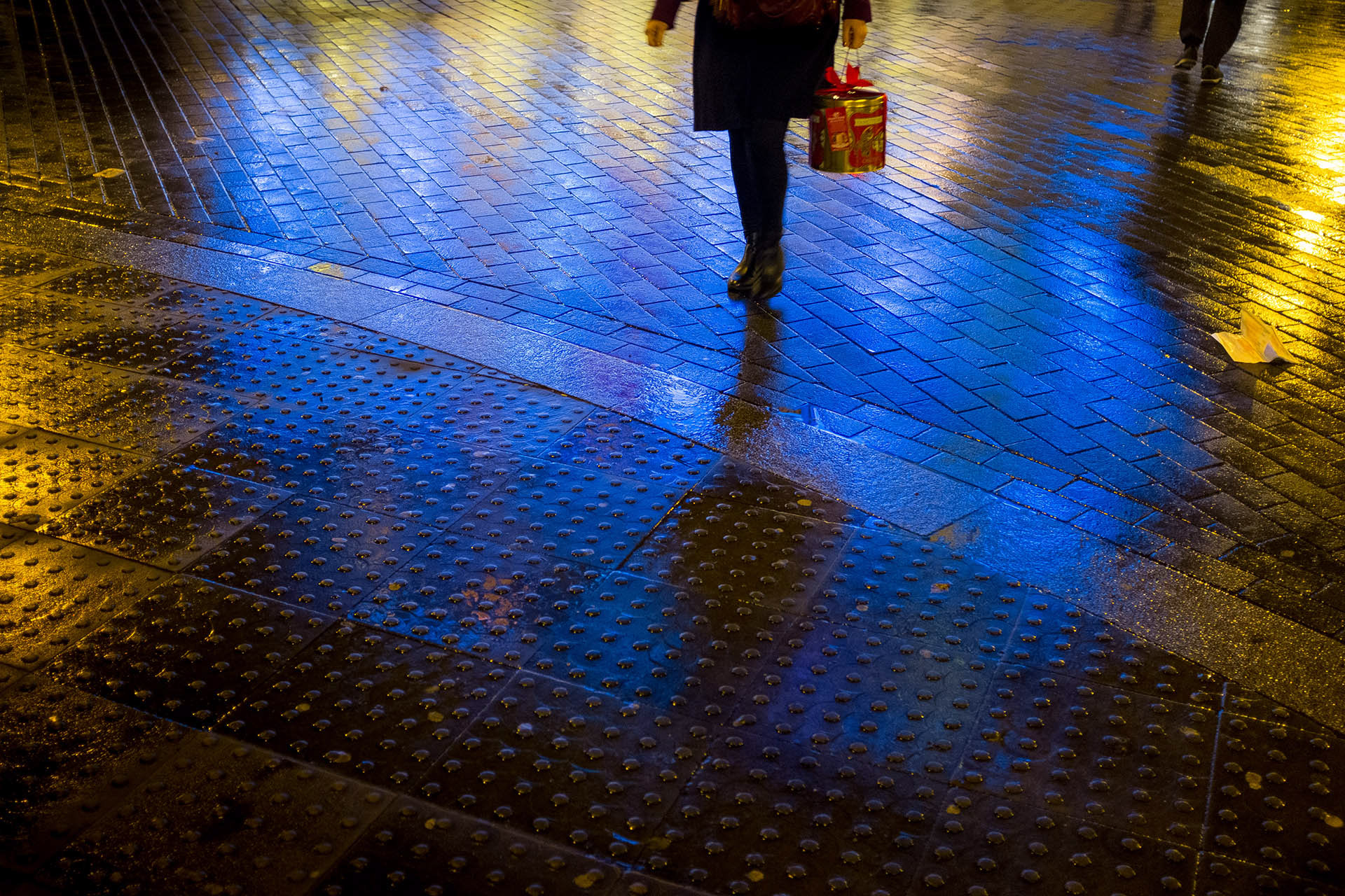 A pedestrian crosses the road outside the Old Vic Theatre, London