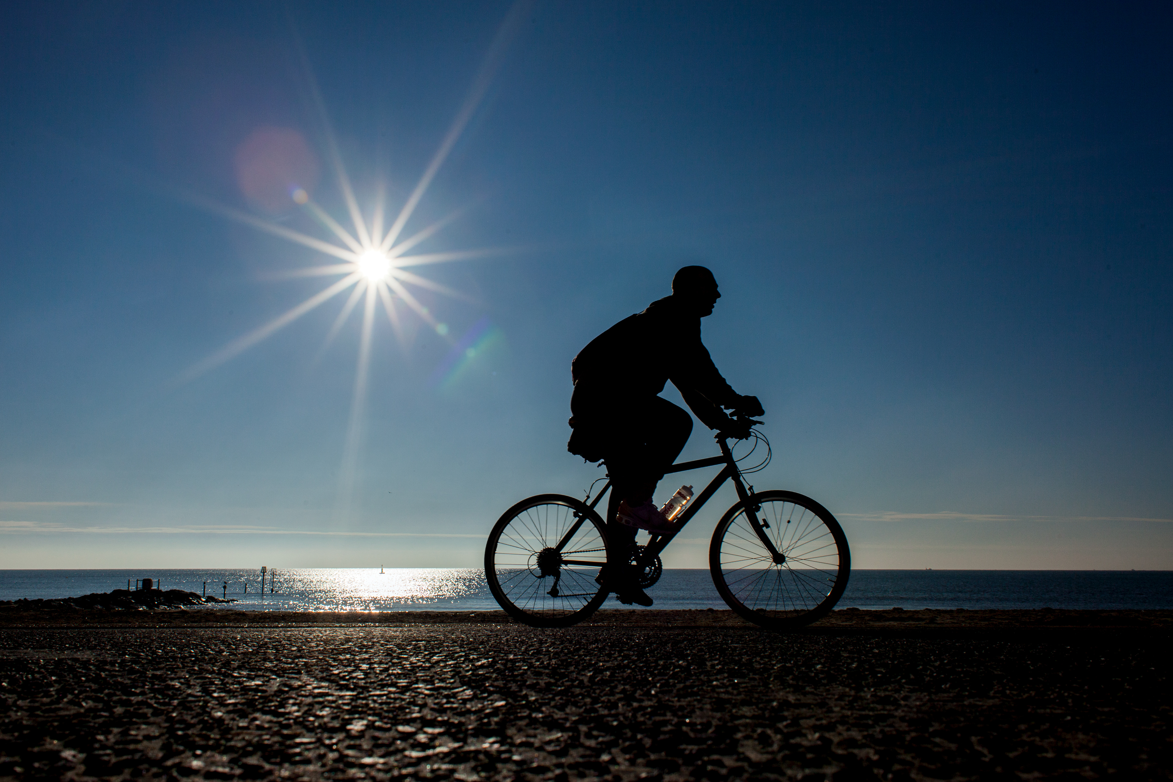 Cyclist on the prom at Boscombe Beach, Dorset