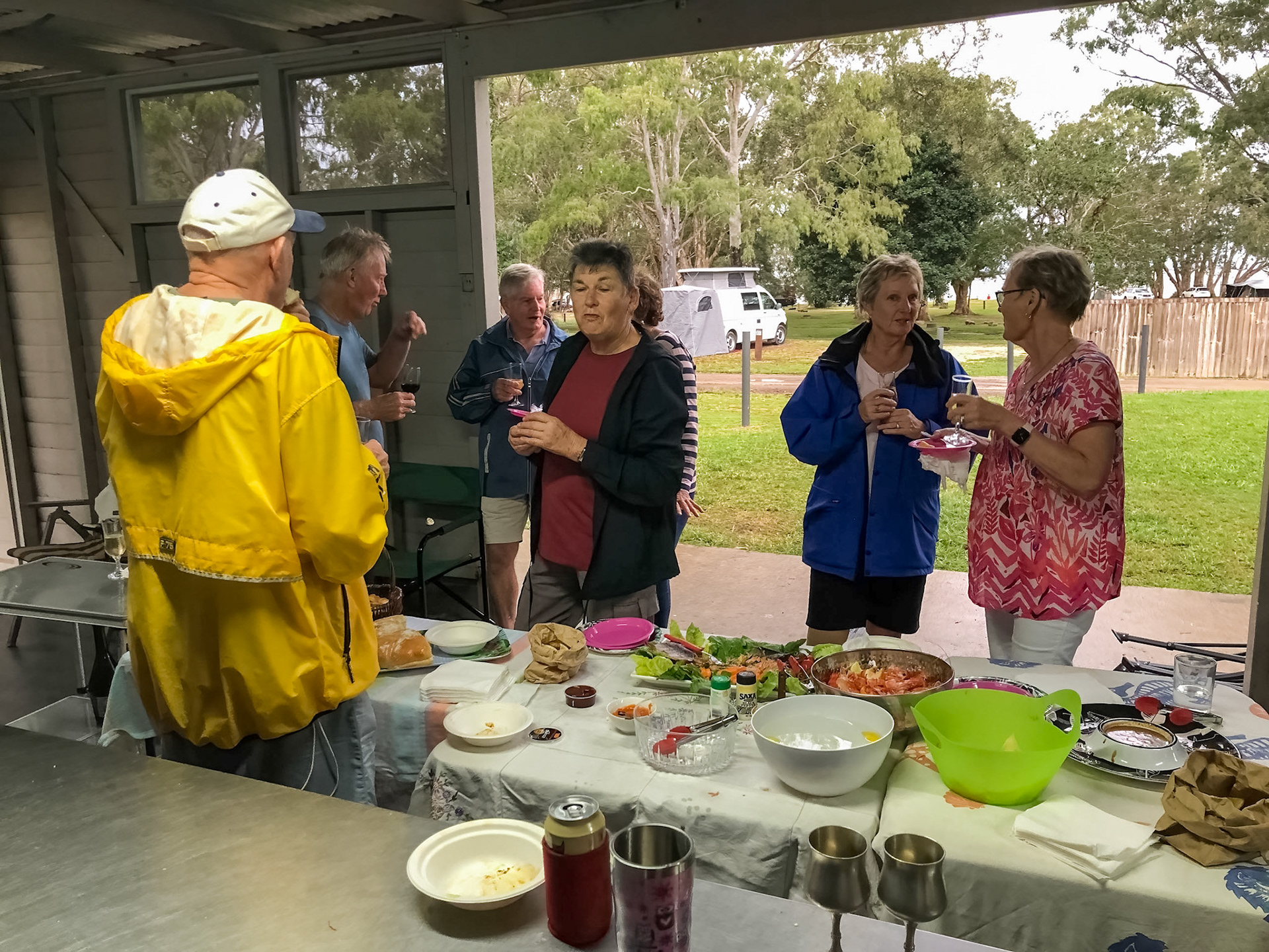 Party in the camp kitchen, sheltered from rain