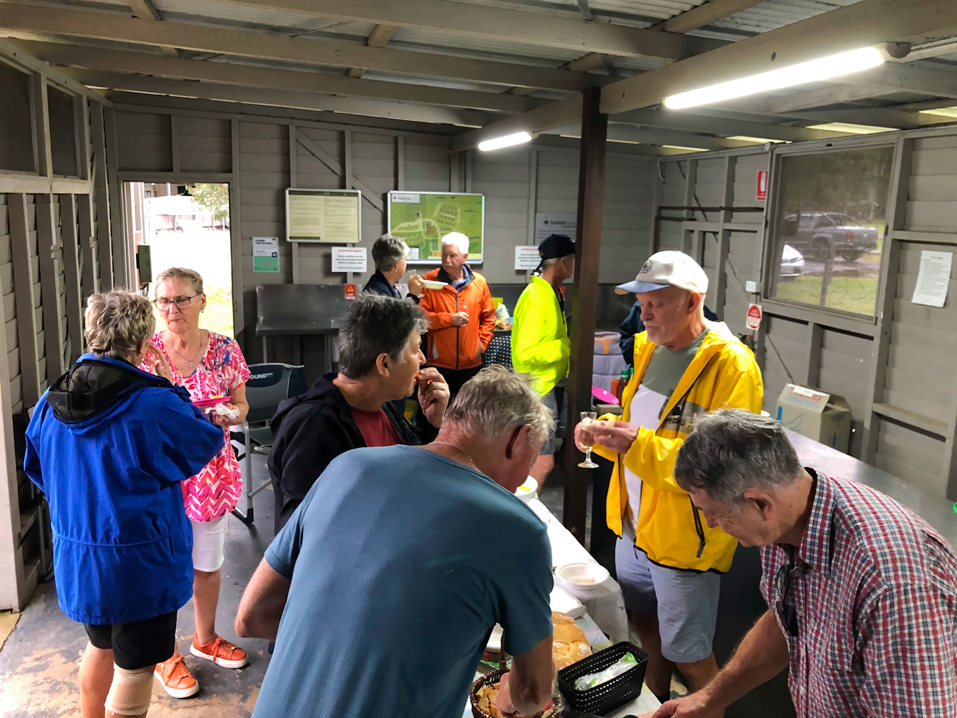 Party in the camp kitchen, sheltered from rain
