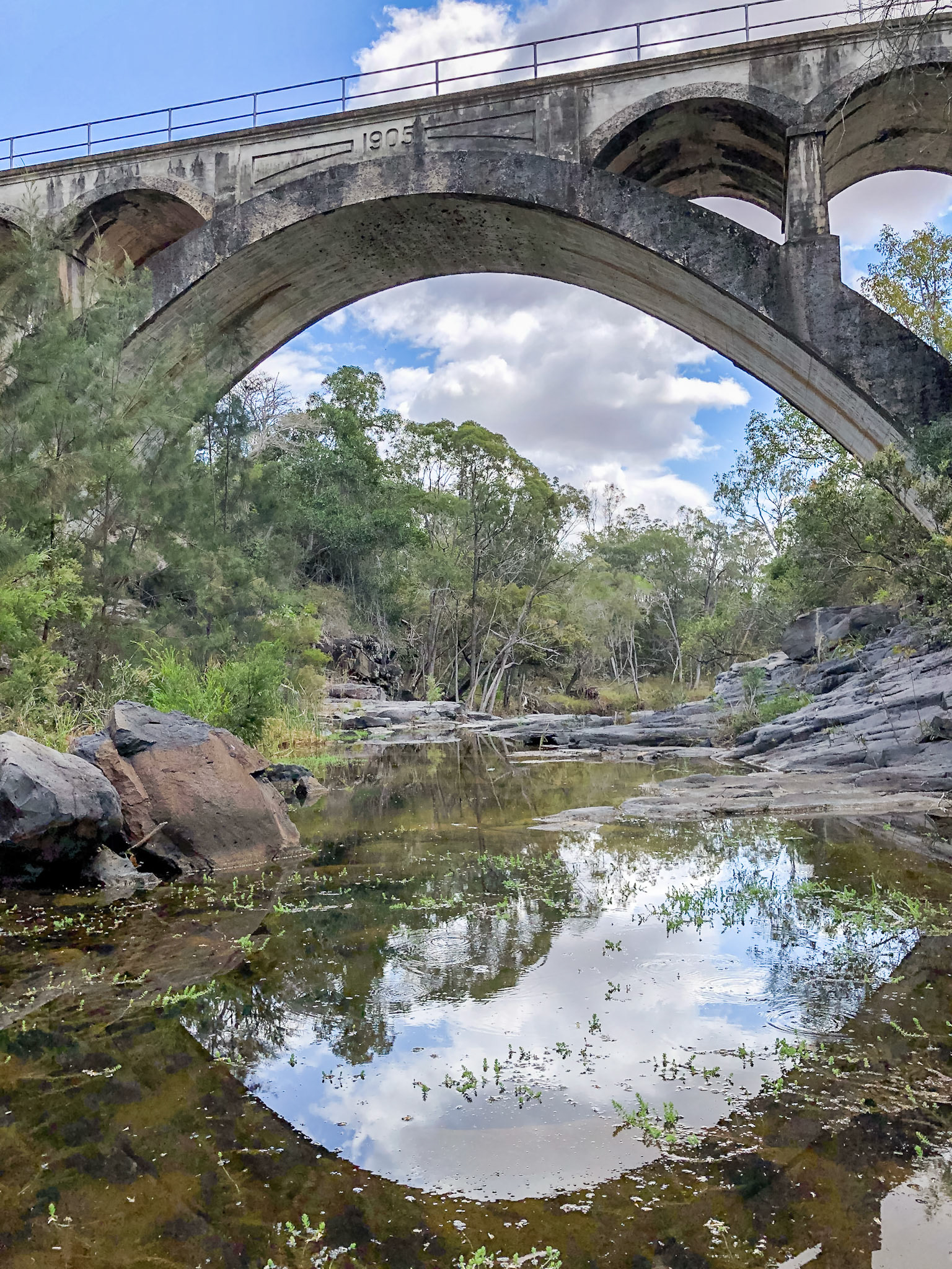 Reflection of Chowey Bridge in the water of Deep Creek
