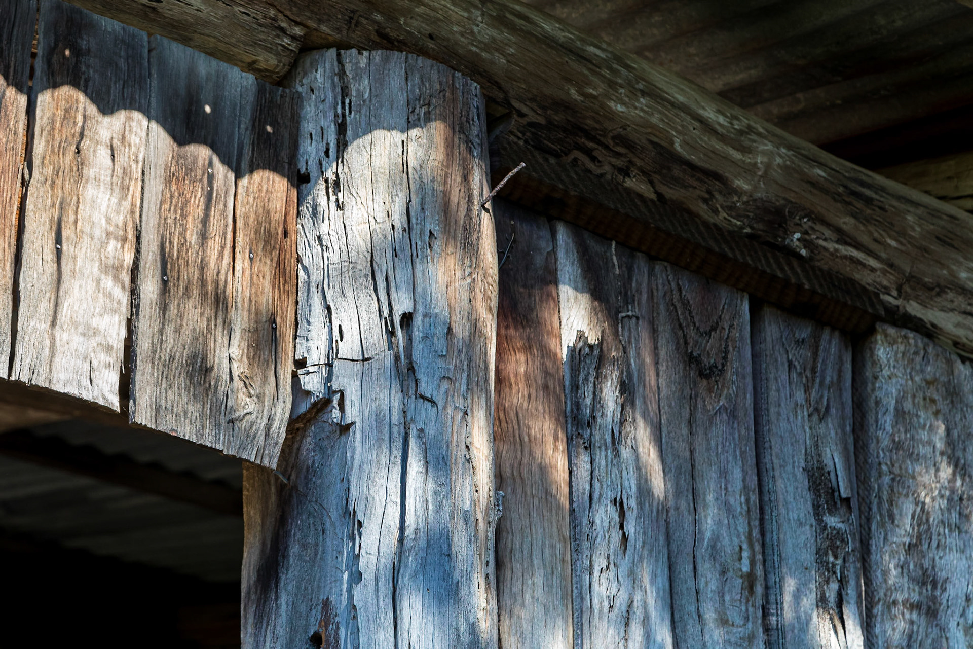 Shed wall made of rough hewn timber