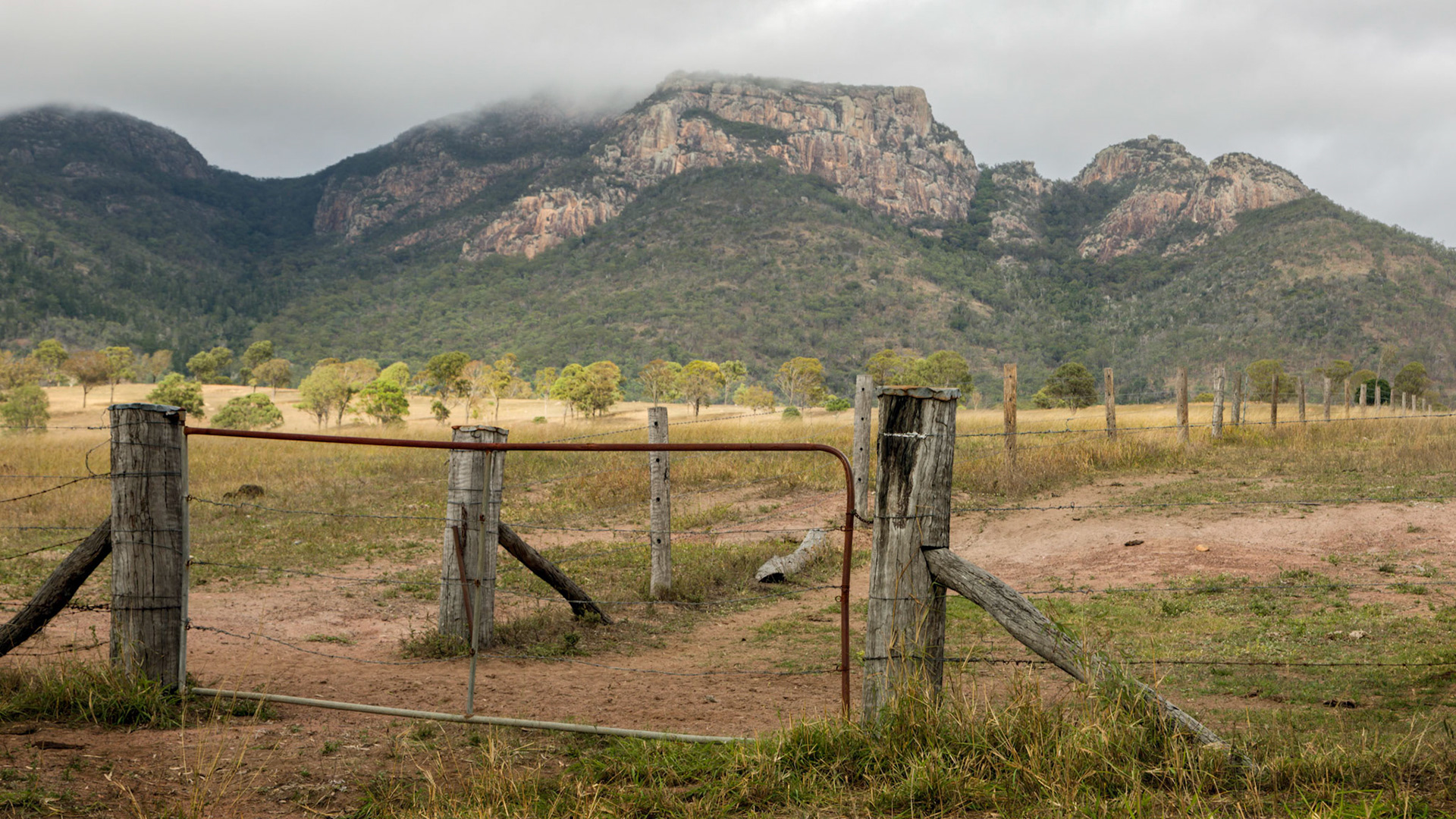 A band of sunshine approaching the cloud shrouded top of Mount Walsh.