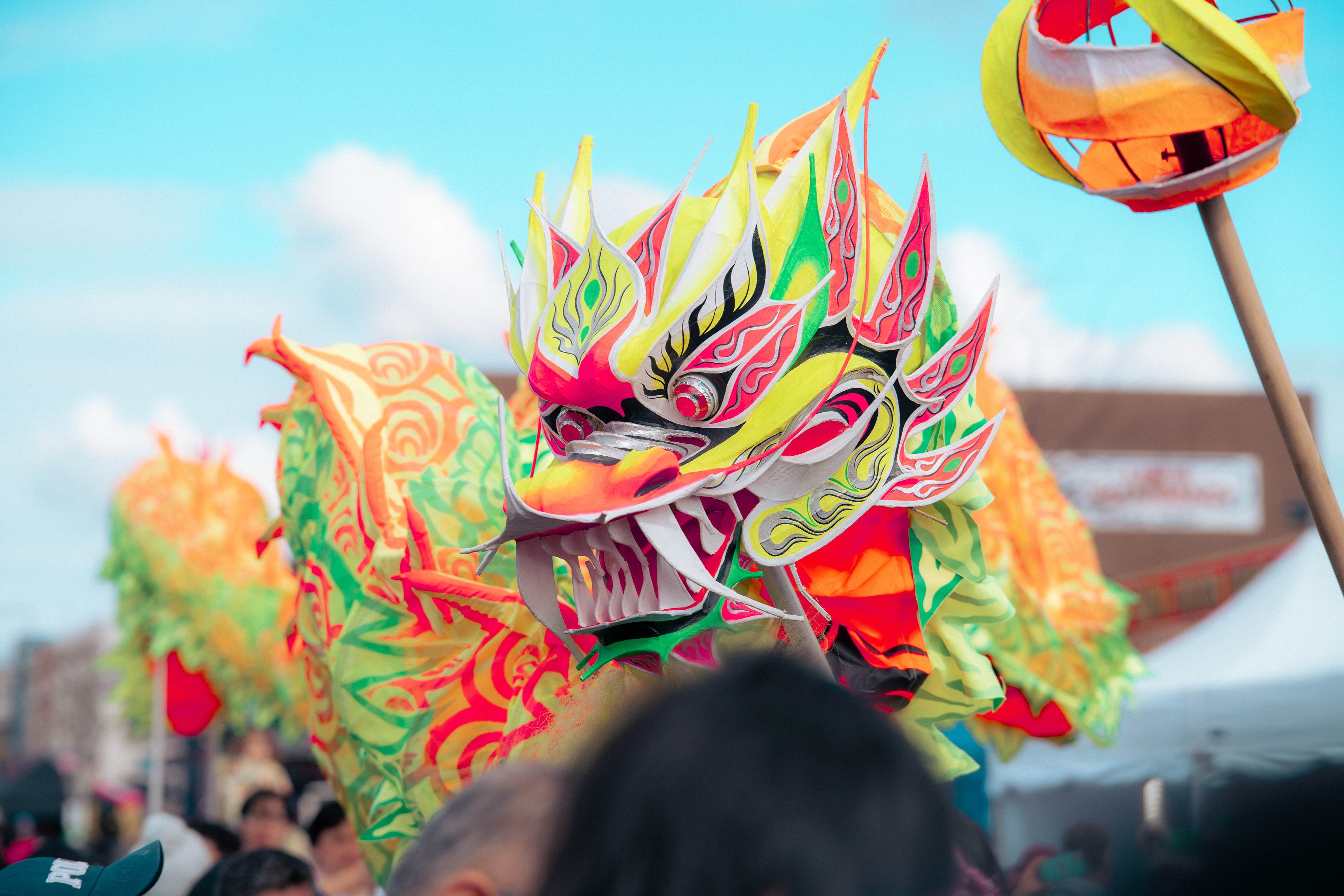 Dragon being held up by people.