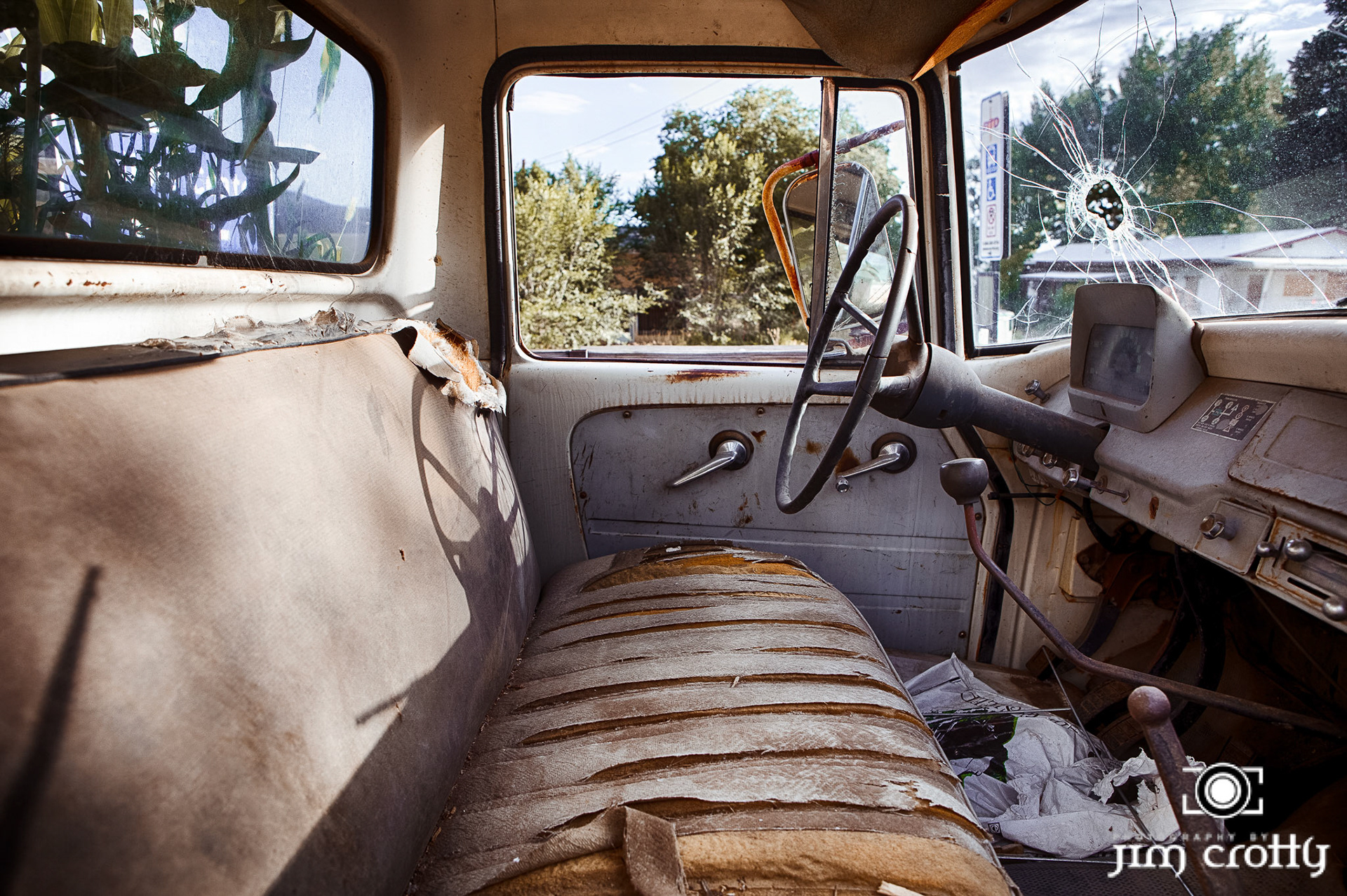 Old cars and landscape in Questa, New Mexico by Jim Crotty