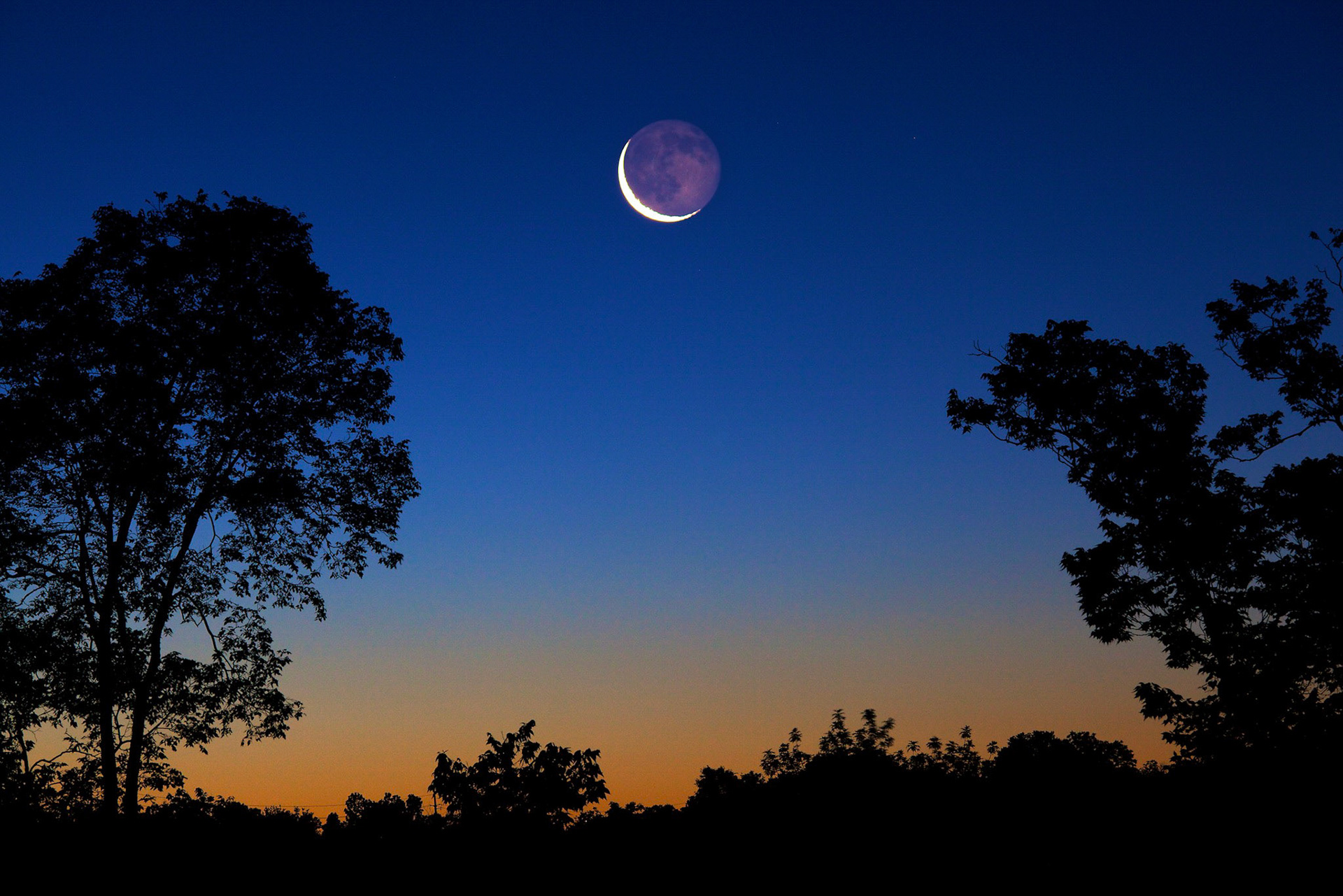 Dawn and crescent moon on JUne 10 2010 from Dayton Ohio by Jim Crotty