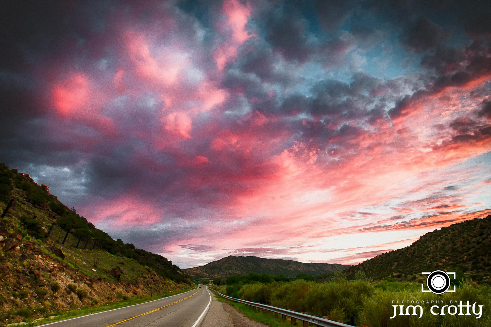 Summer storm sky over the road between Taos and Santa Fe New Mexico by Jim Crotty