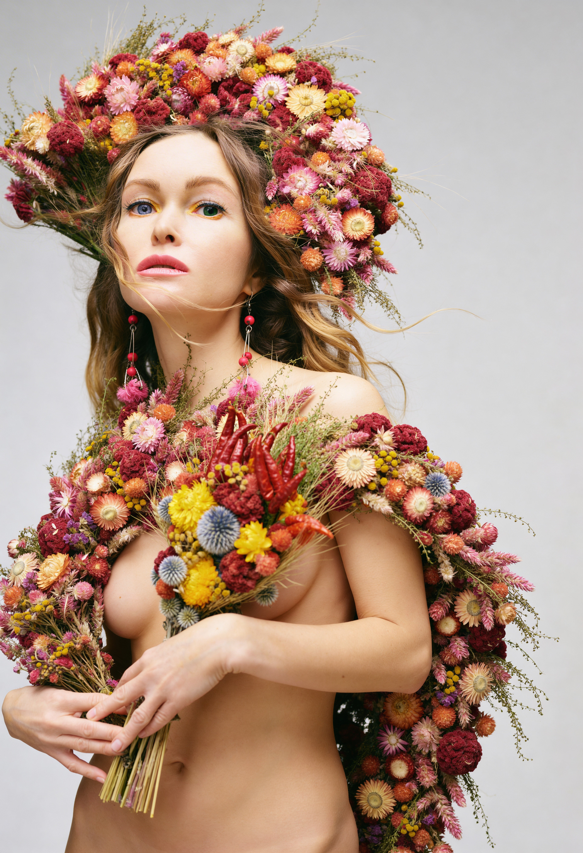 Wider portrait of woman with floral elements showing upper body and posture