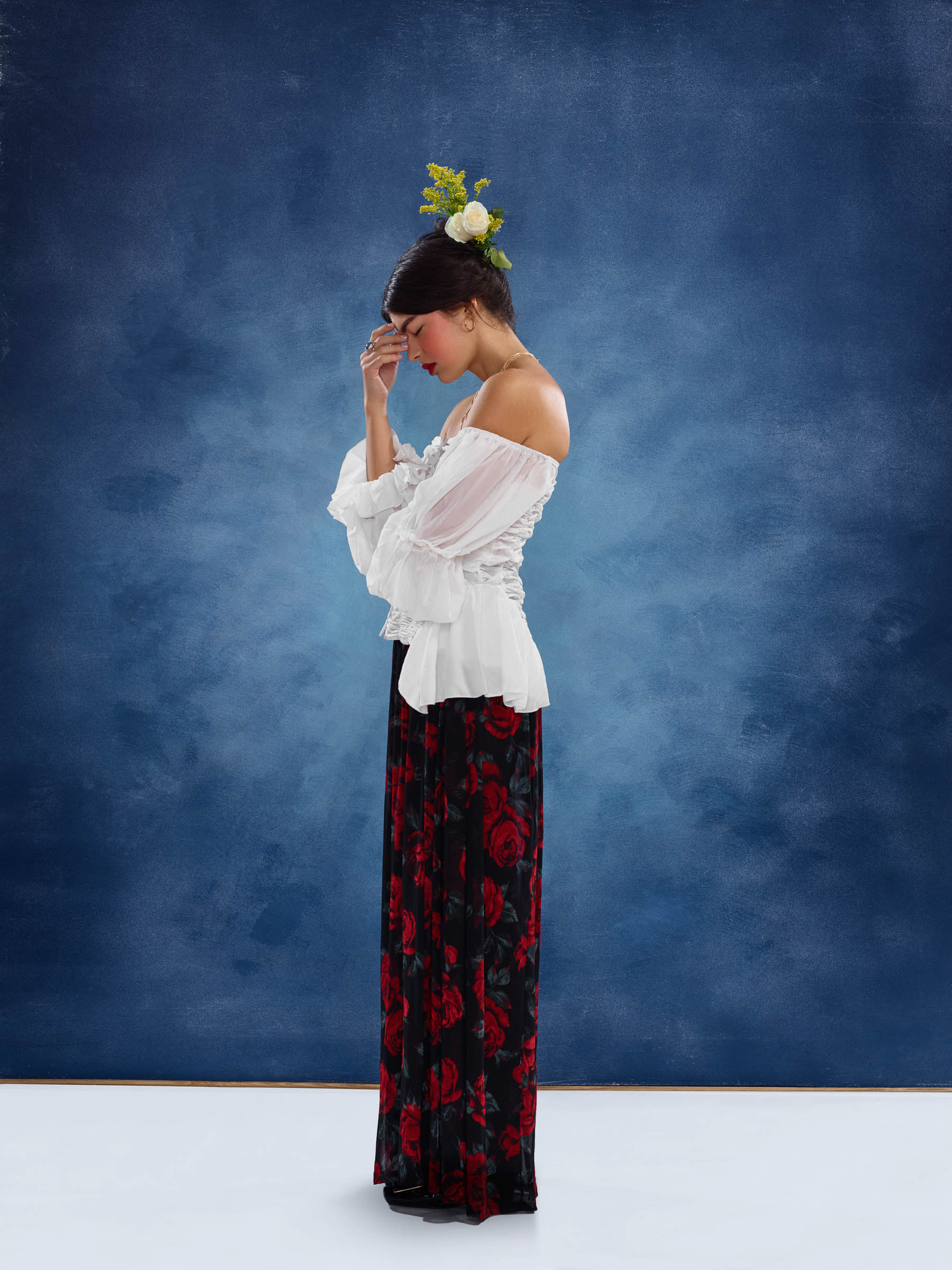 Frida inspired side profile portrait with hand on forehead in shadow silhouette