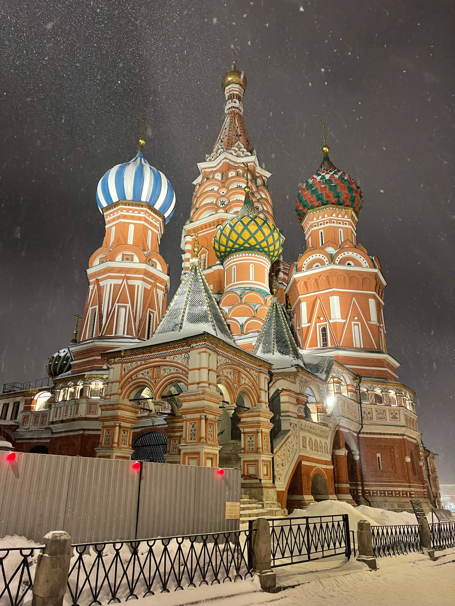Saint Basils Cathedral Moscow at night in snowstorm with illuminated domes