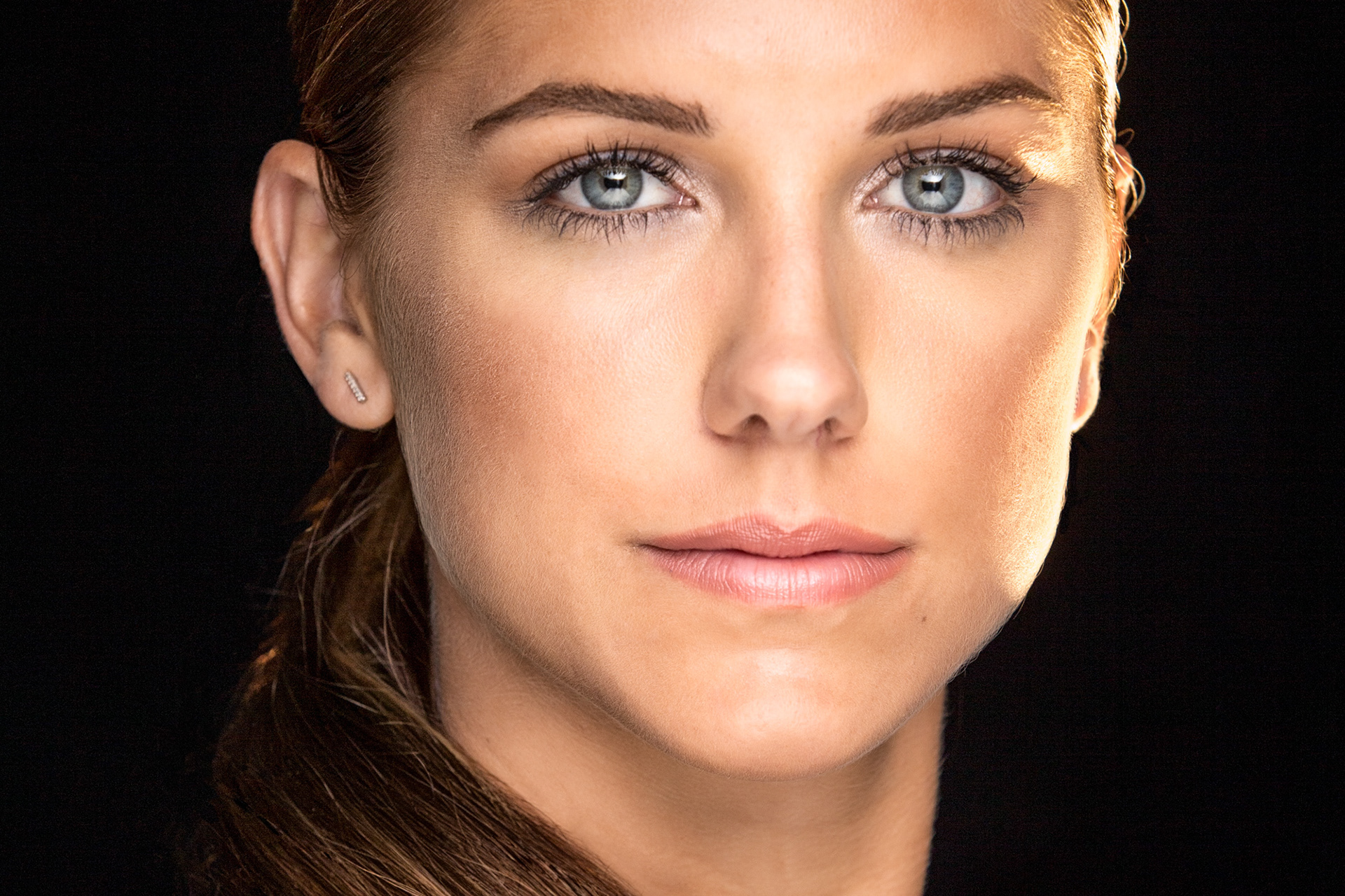 Studio portrait of Alex Morgan photographed with dramatic lighting for editorial sports portrait photography.