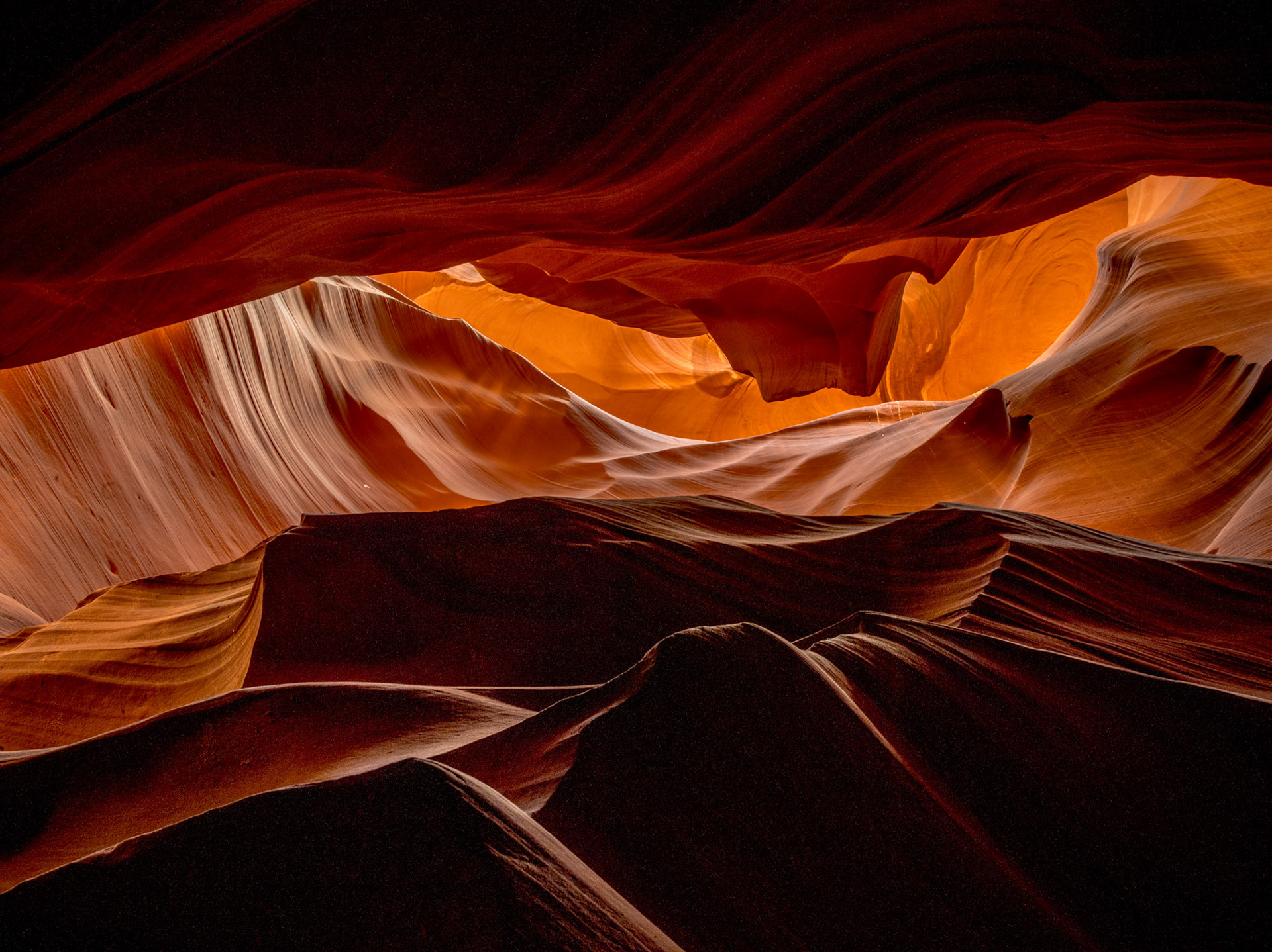 Light rays entering Antelope Canyon illuminating red sandstone walls