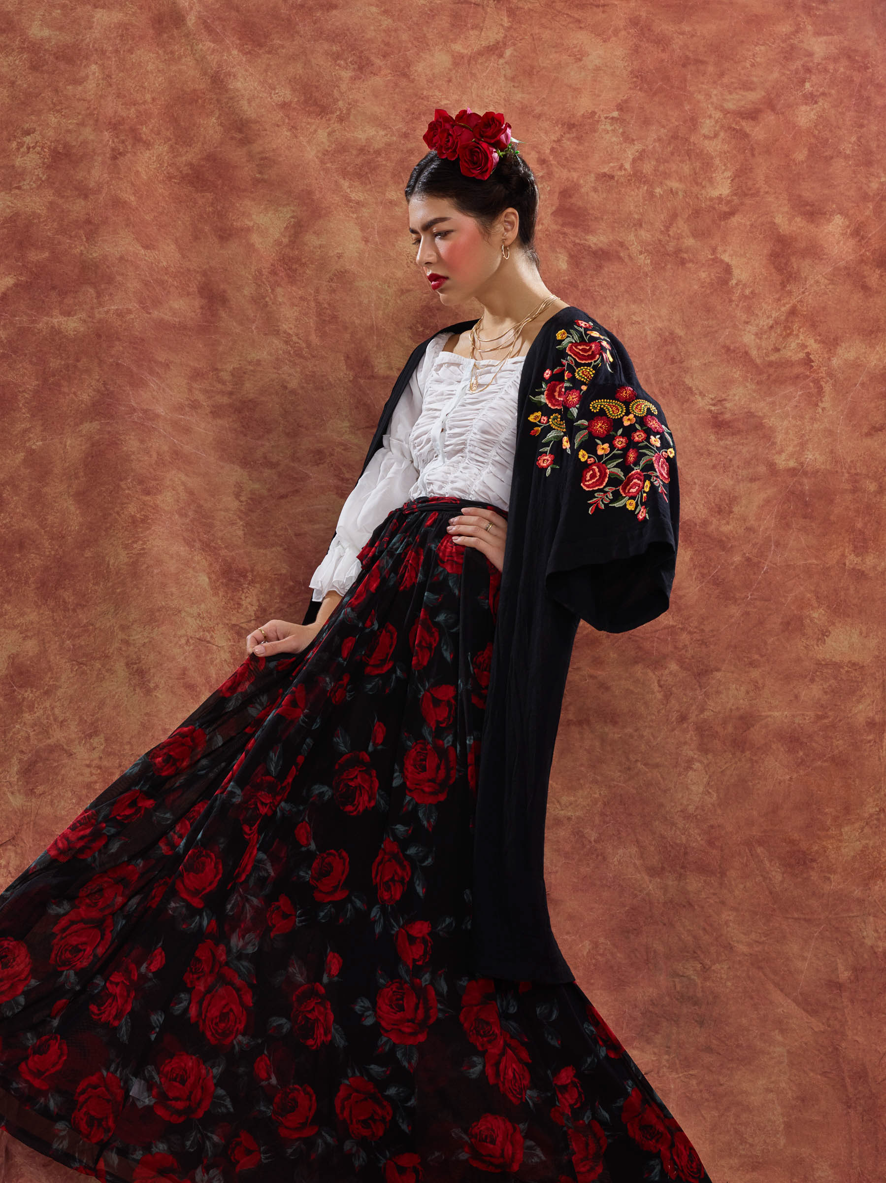 Frida inspired portrait of woman turning with flowing dress and flower in hair