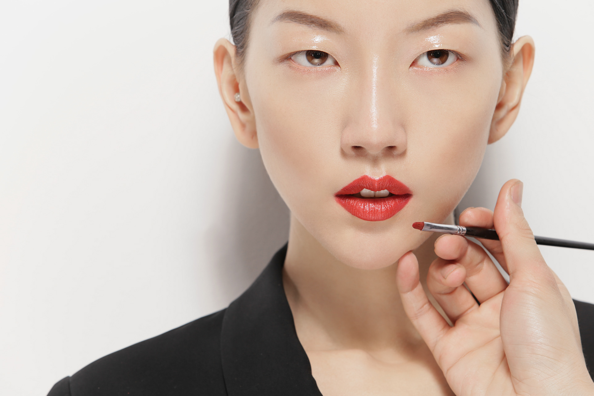 Studio beauty headshot highlighting facial features with soft light.