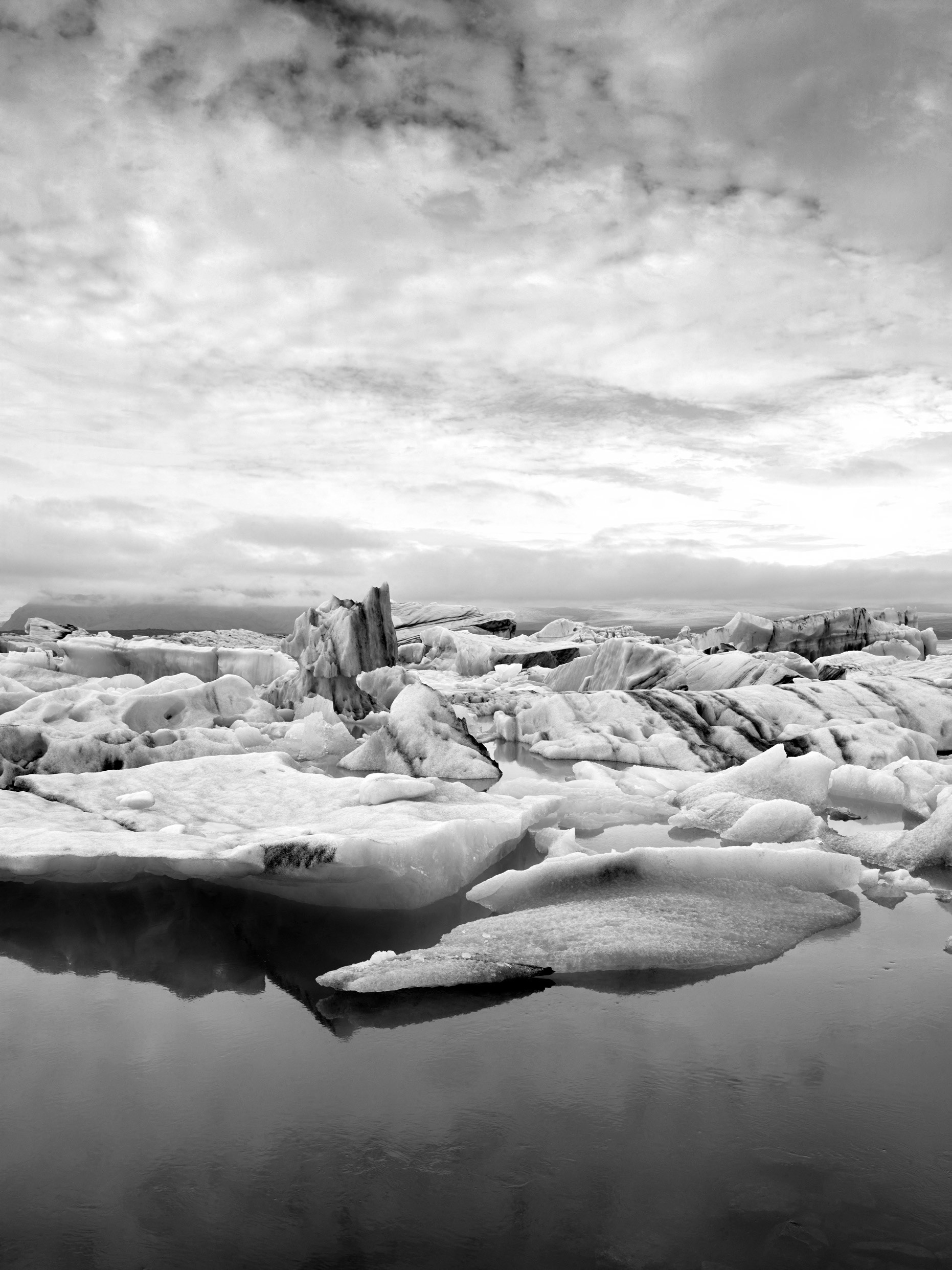 Black and white image of icebergs clustered on Diamond Beach Iceland