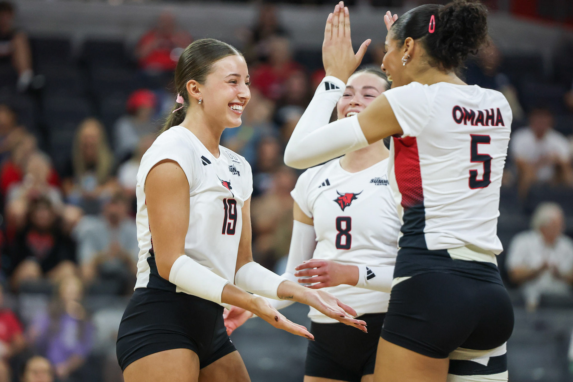 Omaha Mavericks outside hitters Hayden Hart (19) and Faith Venable (5), along with setter Maddie Stuesser (8), celebrate a point during a volleyball match against the Kansas State Wildcats at Baxter Arena in Omaha, Nebraska, on Saturday, September 19, 2026. Photo by Abdoul Sow.