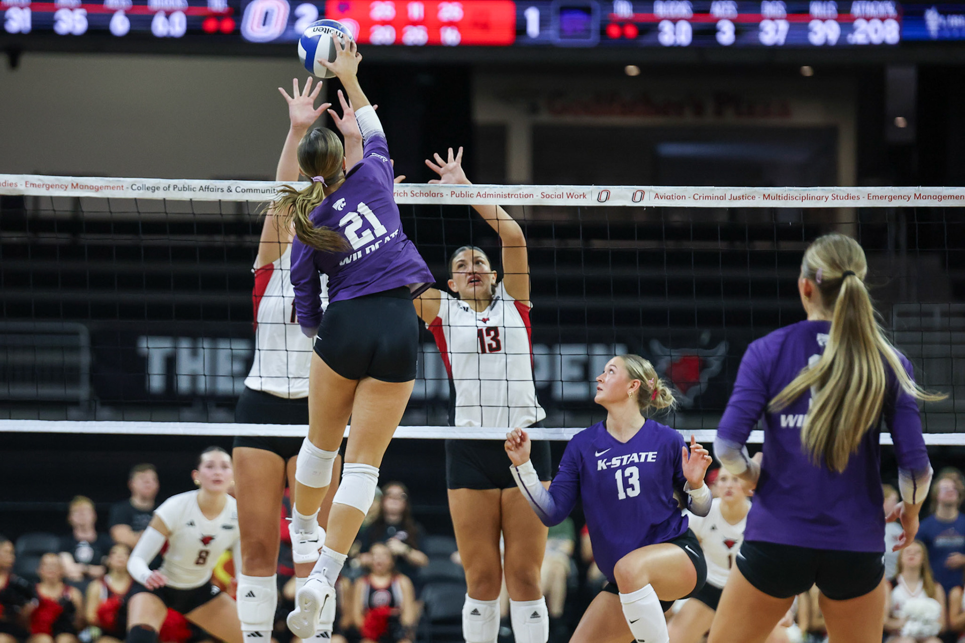 Kansas State Wildcats middle blocker Reese Resmer (21) attacks the ball against Omaha Mavericks middle blocker Dara Obeid (13) during a volleyball match at Baxter Arena in Omaha, Nebraska, on Saturday, September 19, 2026. Photo by Abdoul Sow