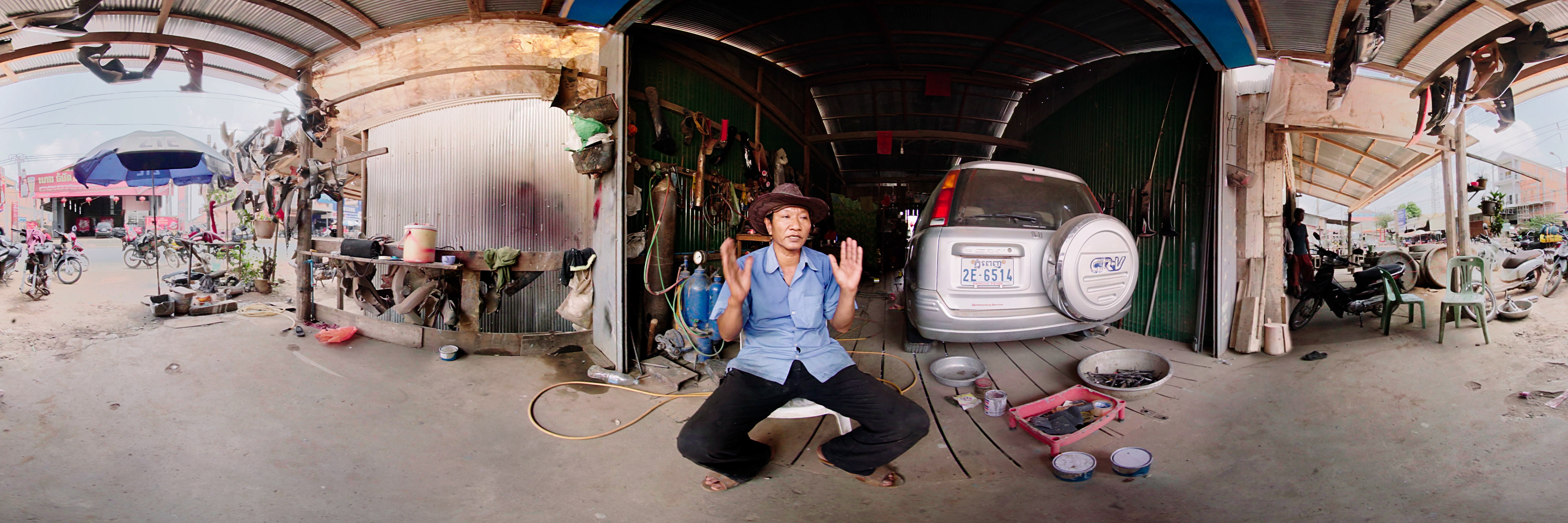 A Combodian motorbike repairman giving an interview
