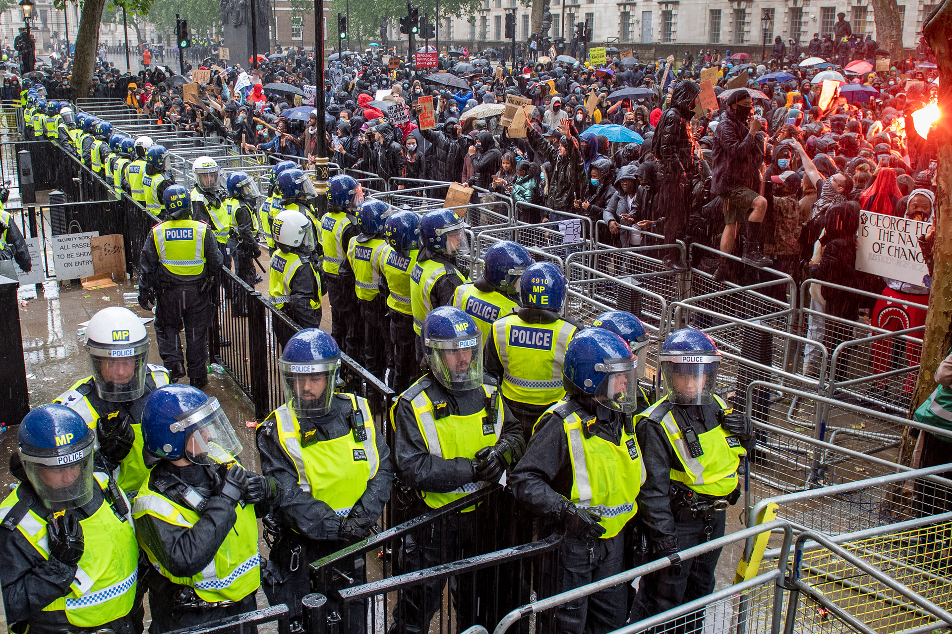 Police wearing riot helmets form a line at the entrance of Downing Street during a Black Lives Matter demonstration in London, United Kingdom.