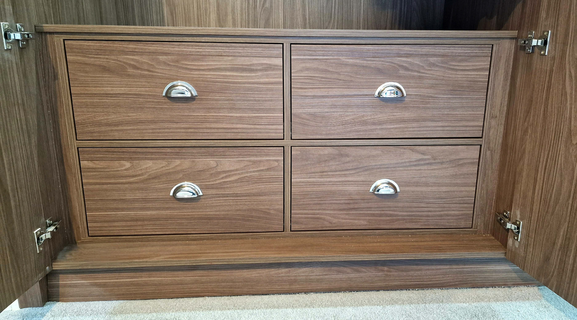 Master bedroom custom fitted wardrobes in Lincoln Walnut. Featuring LED rails and soft close drawers with Blum hardware.