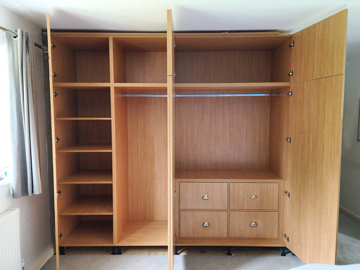 Bespoke, fitted wardrobe with big storage above, 5 deep shelf unit and internal quadruple drawer with soft close blum runners and hinges.