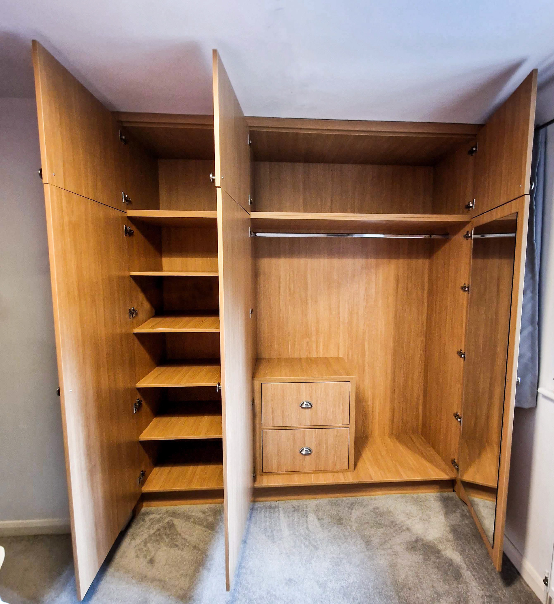 Bespoke, fitted wardrobe with big storage above, 5 deep shelf unit and internal double drawer with soft close blum runners and hinges. Large mirror cut to size and fitted to the far right door.