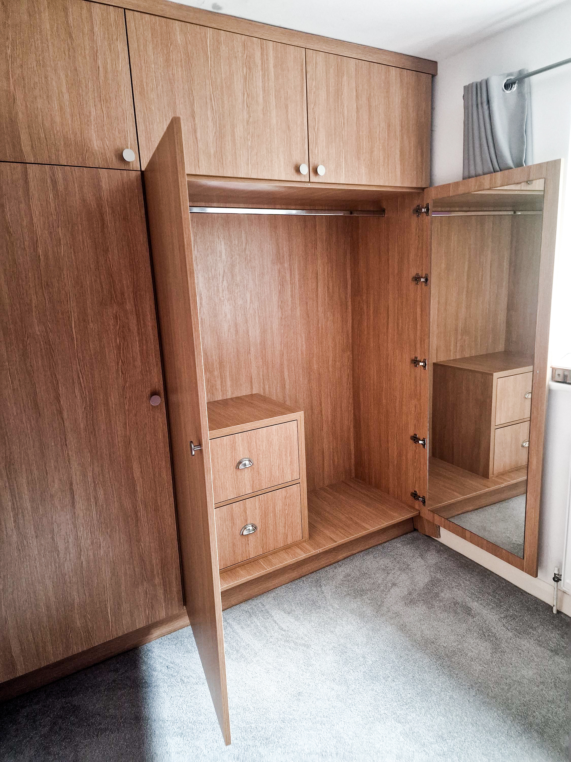 Bespoke, fitted wardrobe with big storage above, 5 deep shelf unit and internal double drawer with soft close blum runners and hinges. Large mirror cut to size and fitted to the far right door.
