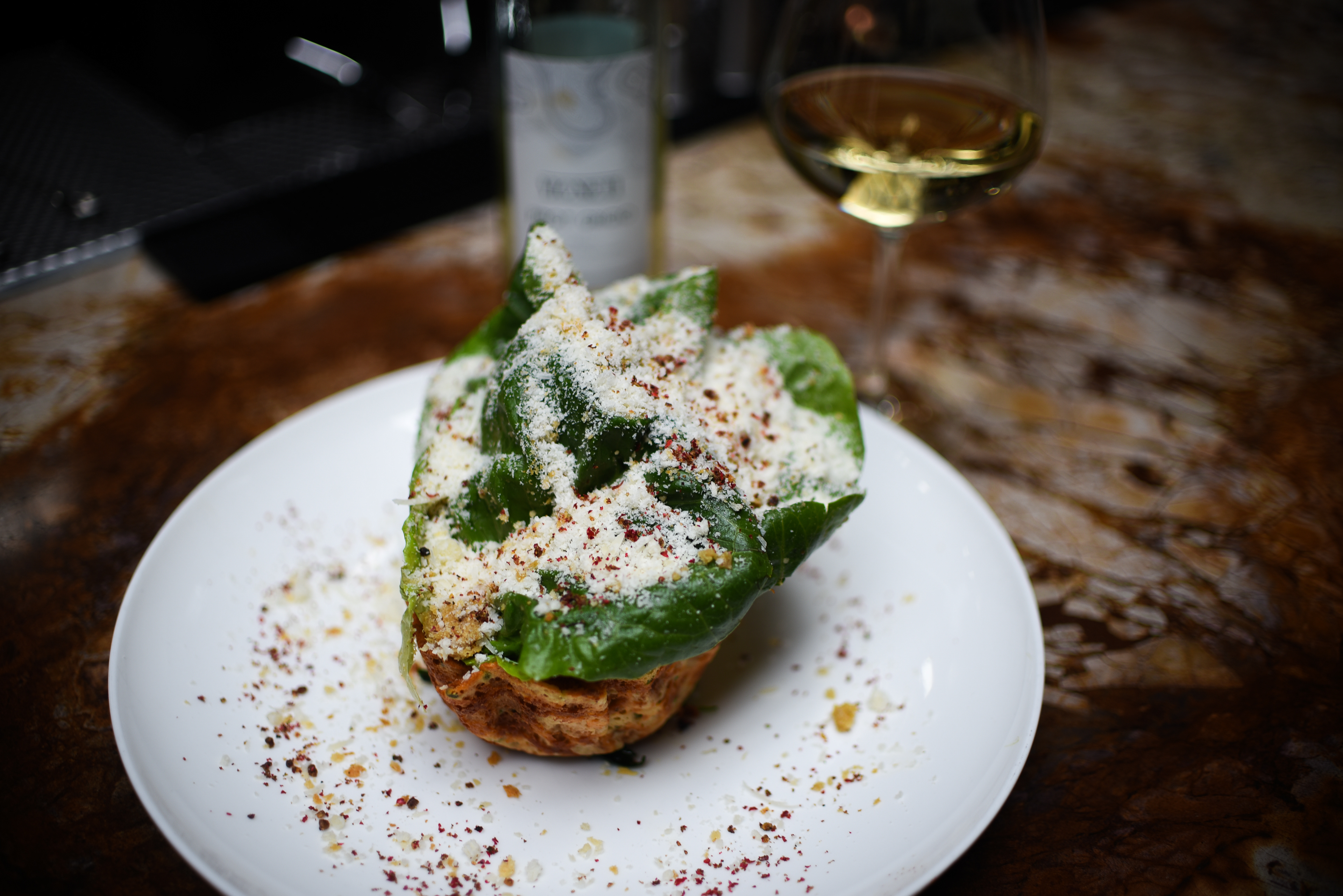 “LIL’ GEM” CAESAR SALAD Grana Padano Snow, Crispy Chicken Skins, Brown Butter Crumble