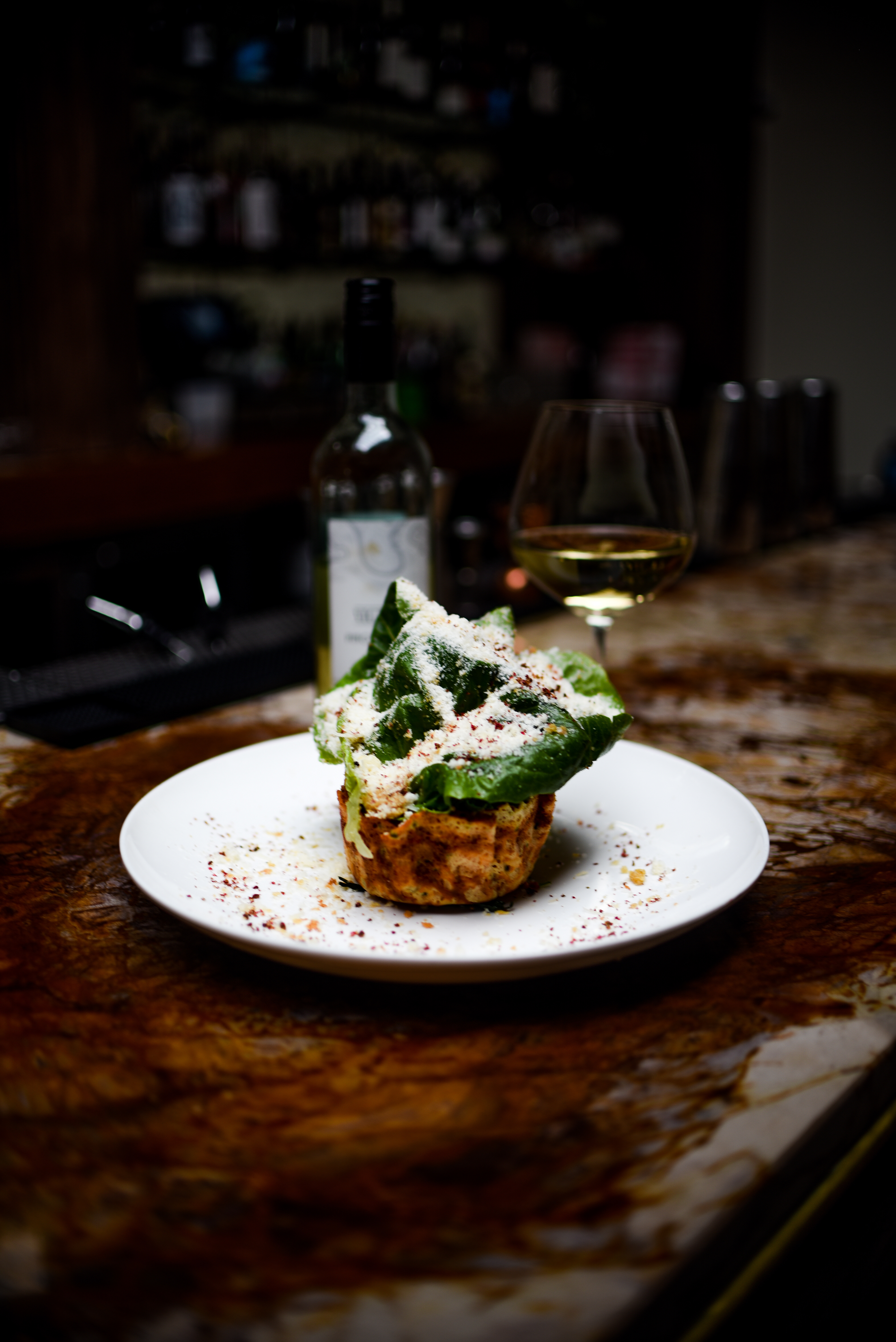 “LIL’ GEM” CAESAR SALAD Grana Padano Snow, Crispy Chicken Skins, Brown Butter Crumble