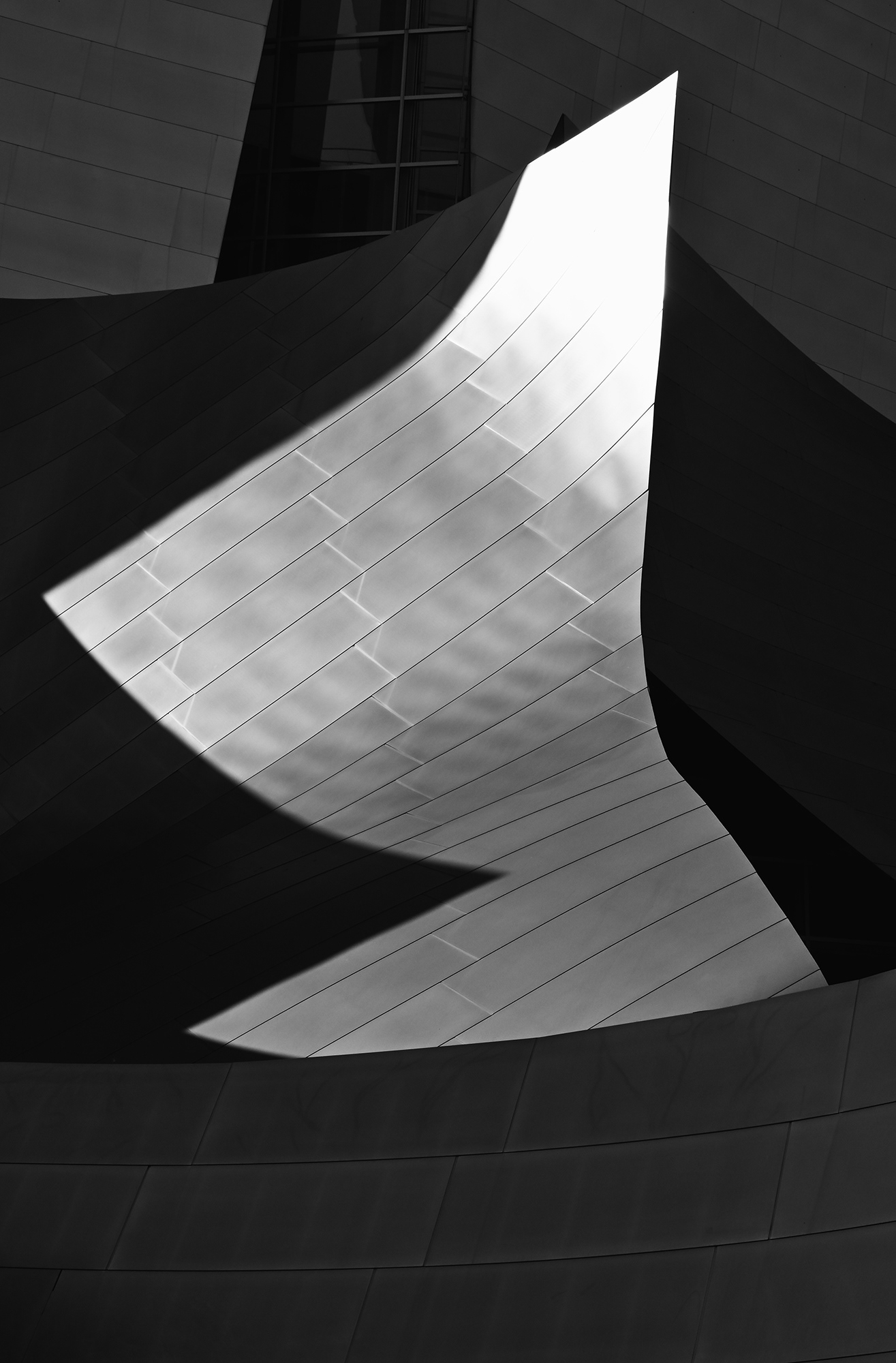 Sunlight striking one of the faces of the many faceted Disney Concert Hall, black and white photograph