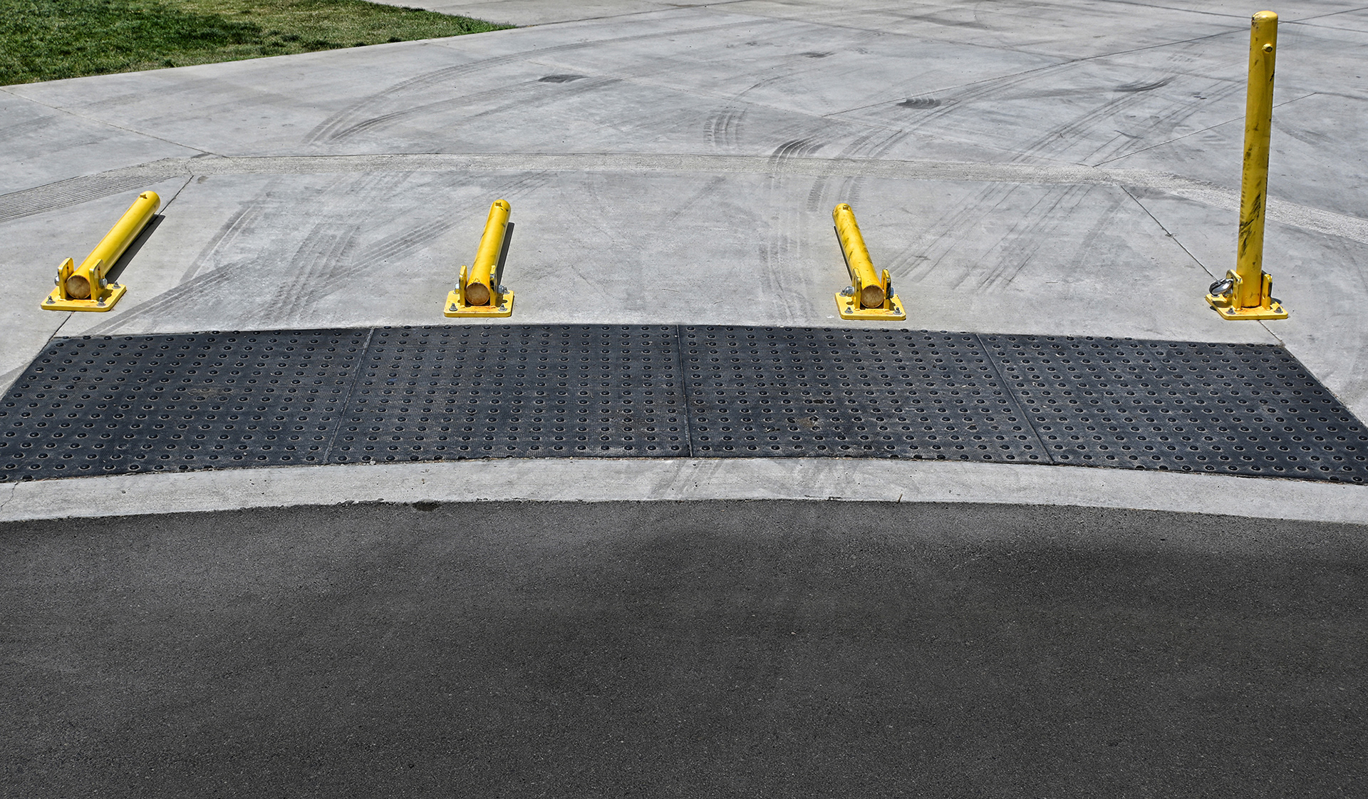 Three Down One to Go, 3 movable bollards laying on the ground for access. 