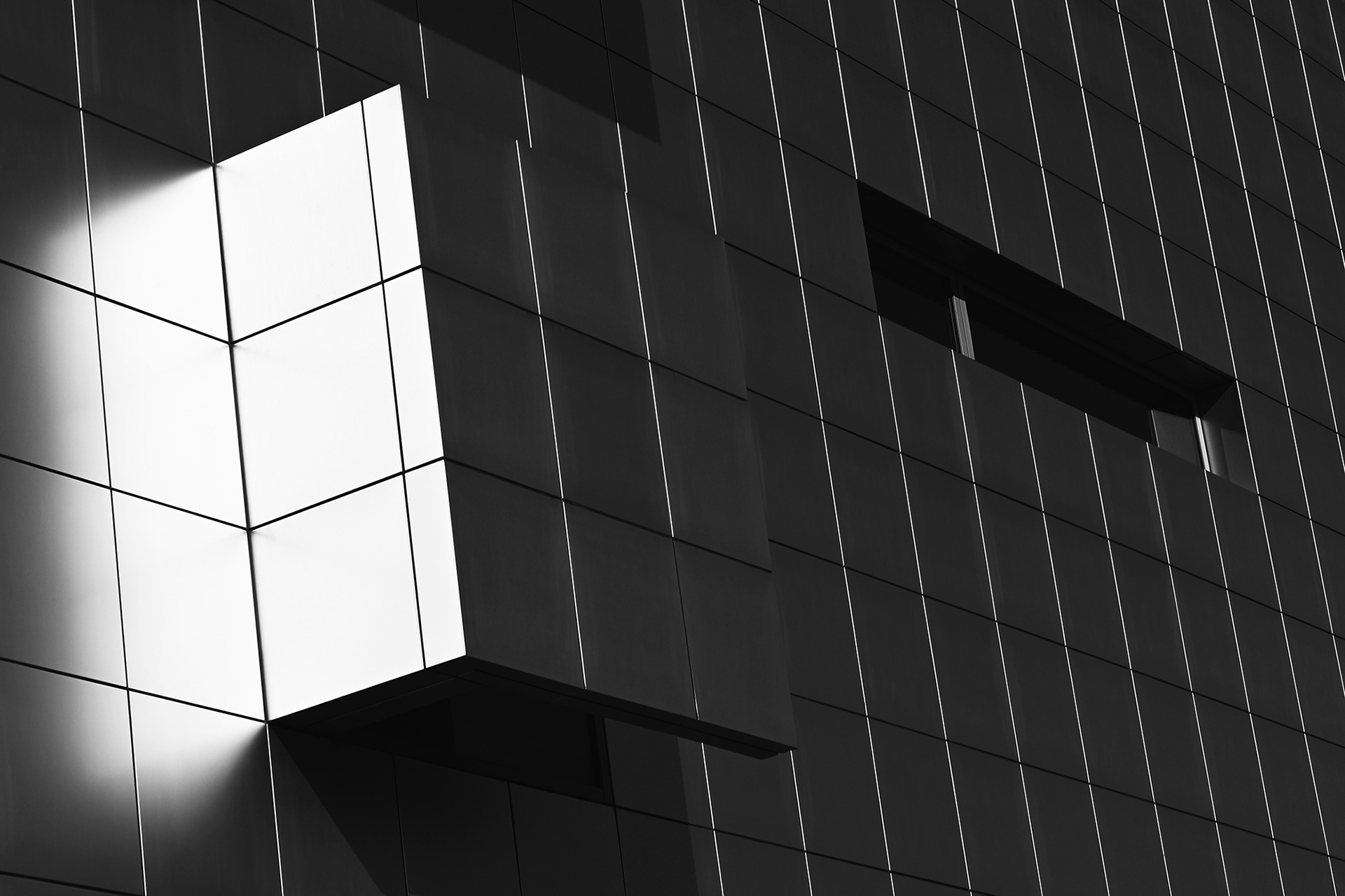 Sun shining and reflection on a section of the Christ Cathedral Cultural Center, black and white photograph