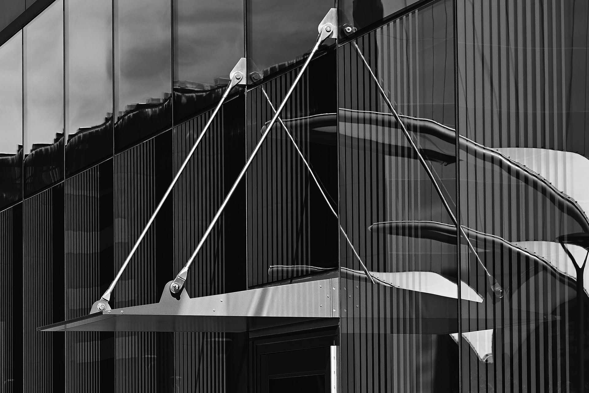 Door Overhang reflecting in the UCI Health building, black and white photograph