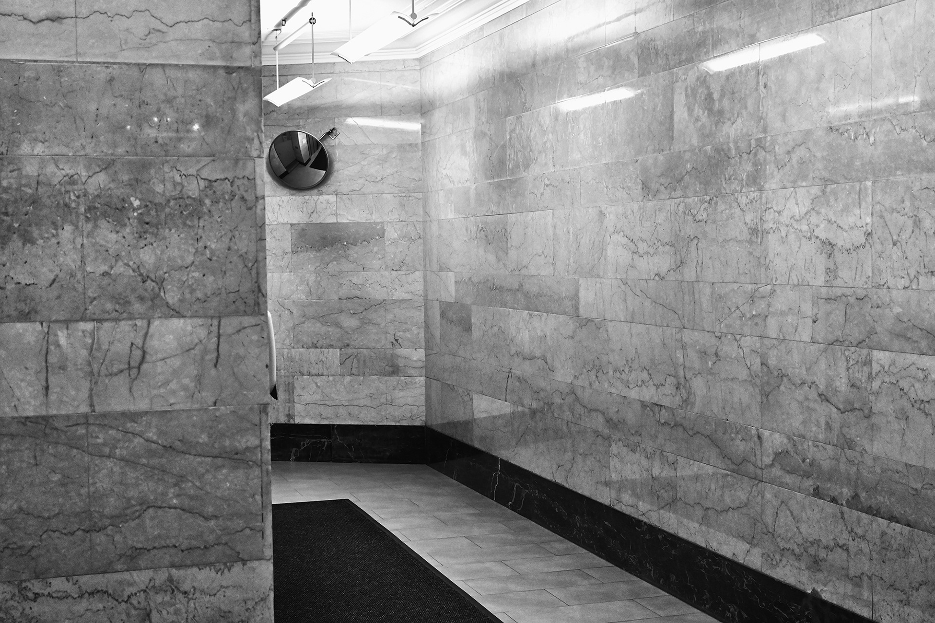 Building lobby with security mirror, black and white photograph