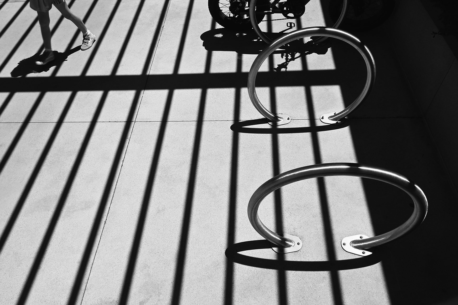 Bike Rack, Shadows and Sneakers, black and white photograph