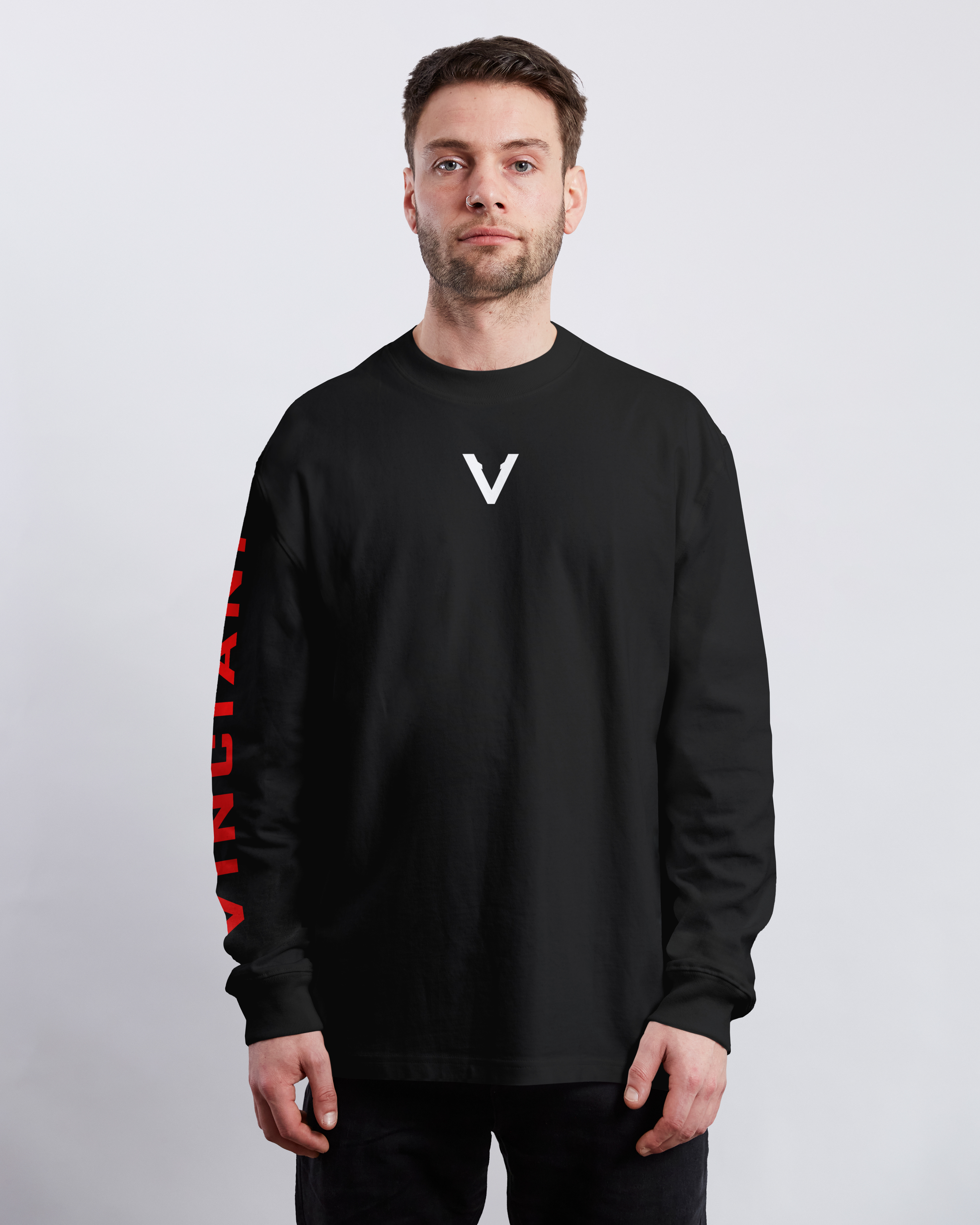Vinciani black long sleeve shirt with minimal V logo on chest and red sleeve detailing, modern luxury streetwear on model.