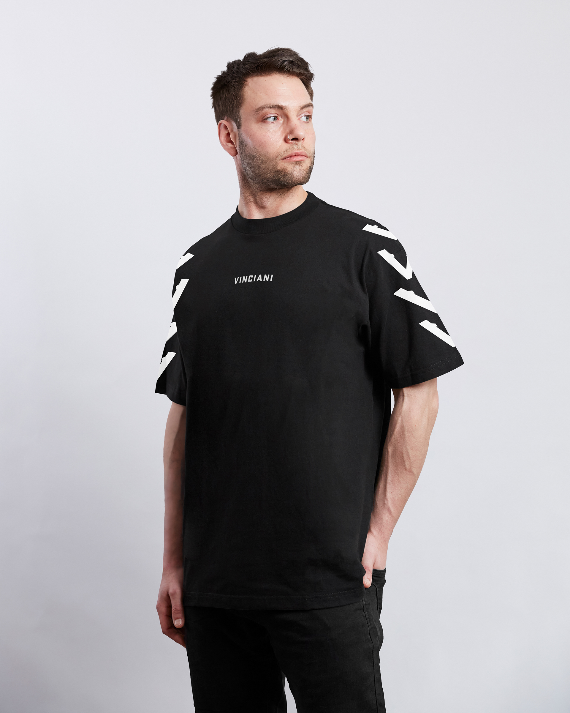 Vinciani black t-shirt with sleeve V stripe design and front logo, modern luxury streetwear shown on male model.