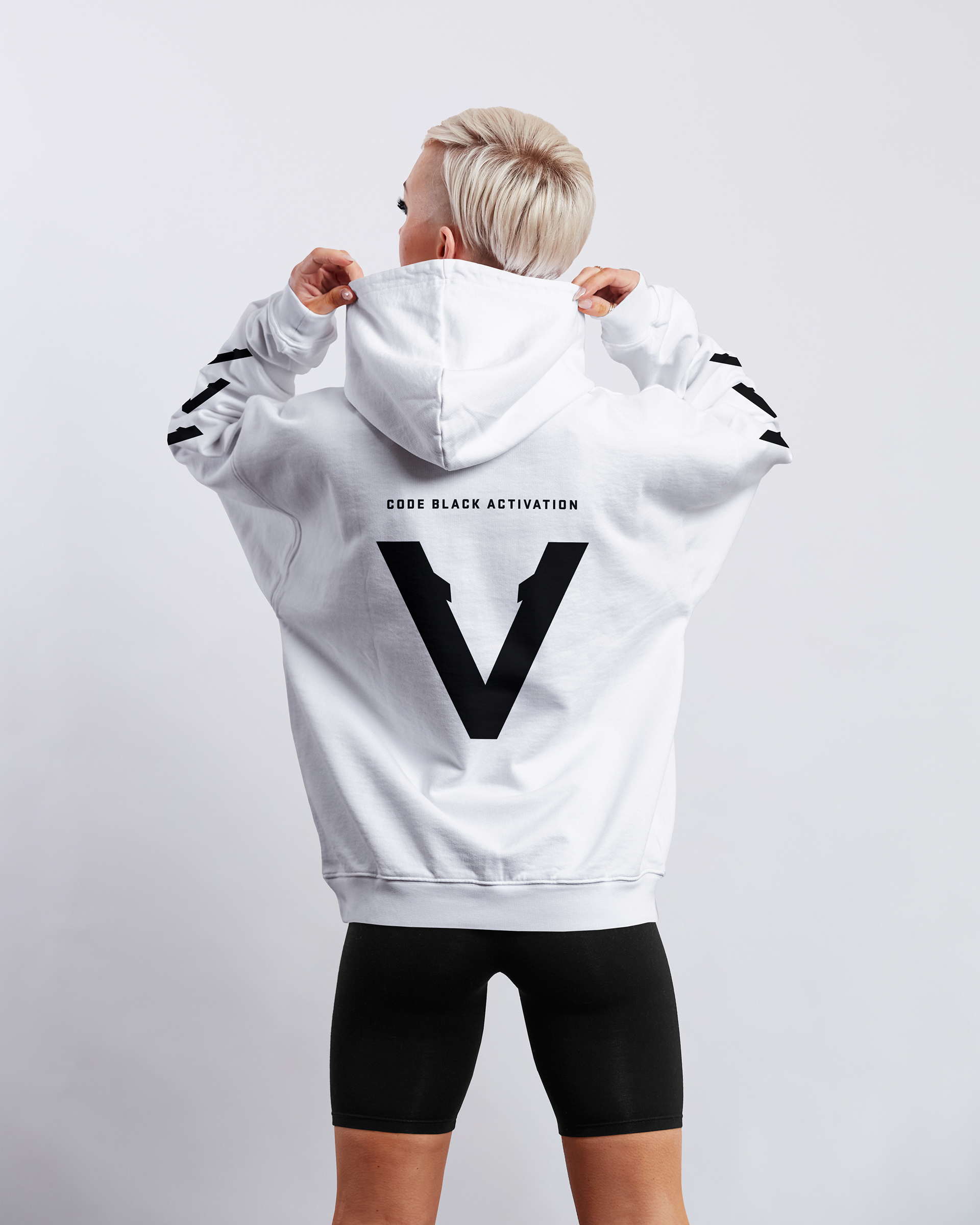 White Vinciani hoodie with black V logo on the back and 'CodeBlack Activation' text, premium streetwear design with sleeve stripe detailing, rear view on model.