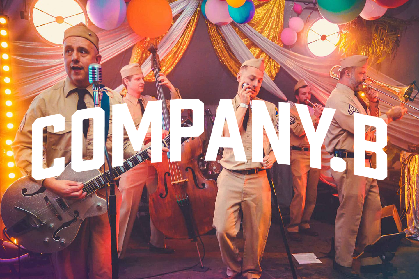 A colourful pcture of 7-piece, Jump Jive band Comany B performing at Camp Wildfire festival. The image is overlayed with the group's new wordmark.